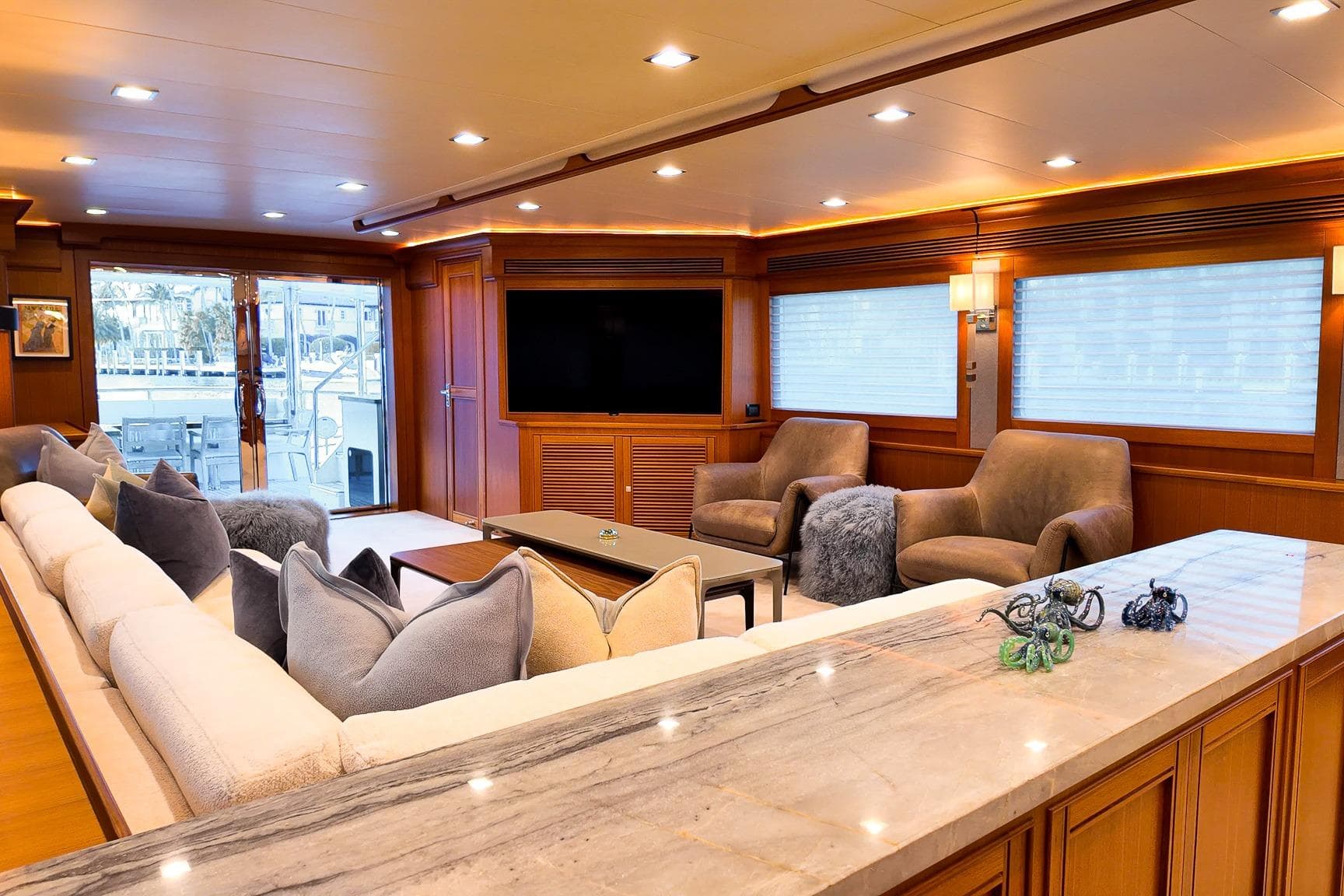 Luxurious interior of 2022 Marlow Voyager Series yacht with plush seating and modern decor.