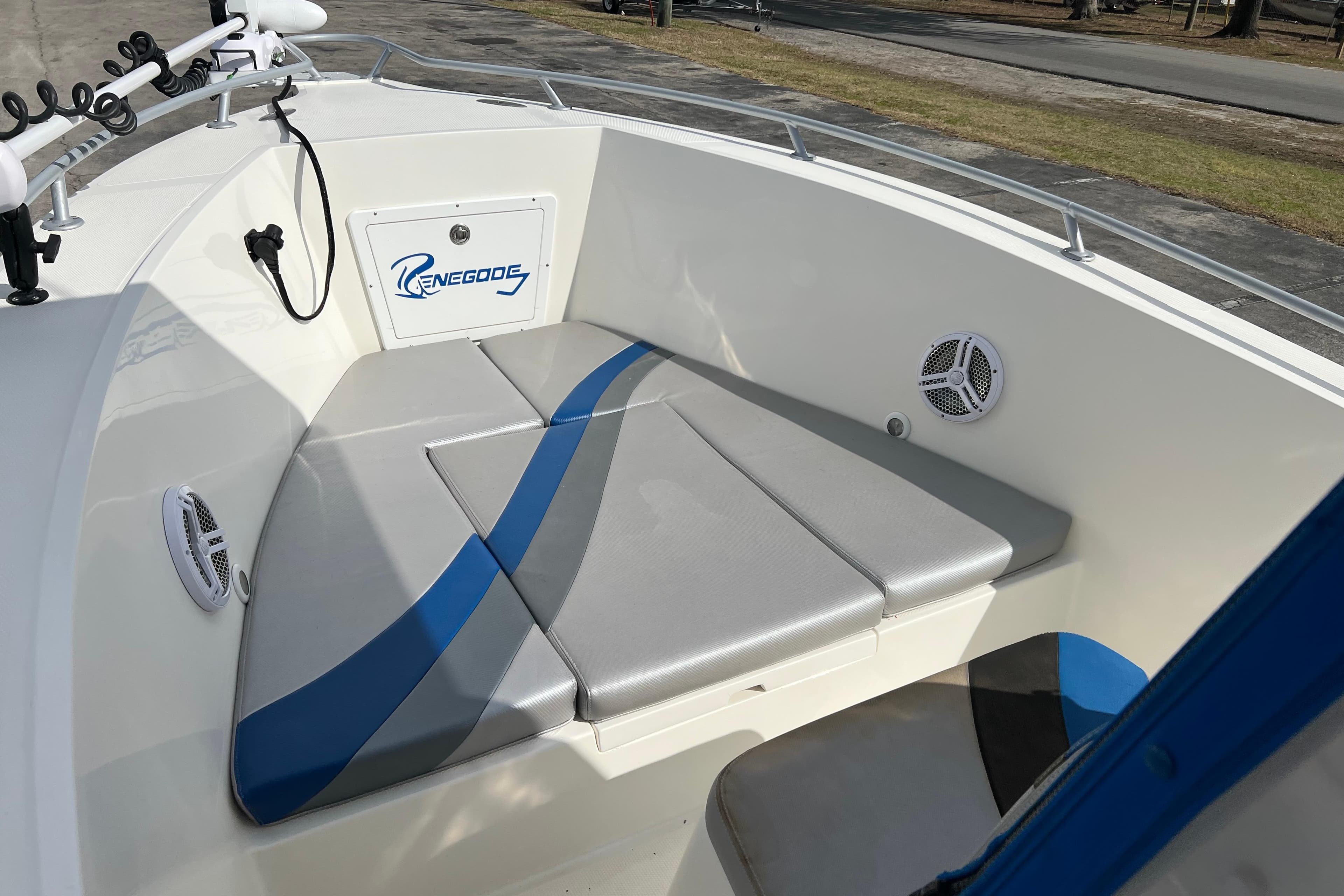 Renegade OF 23 boat interior, 2011 model, featuring cushioned seating and speakers.