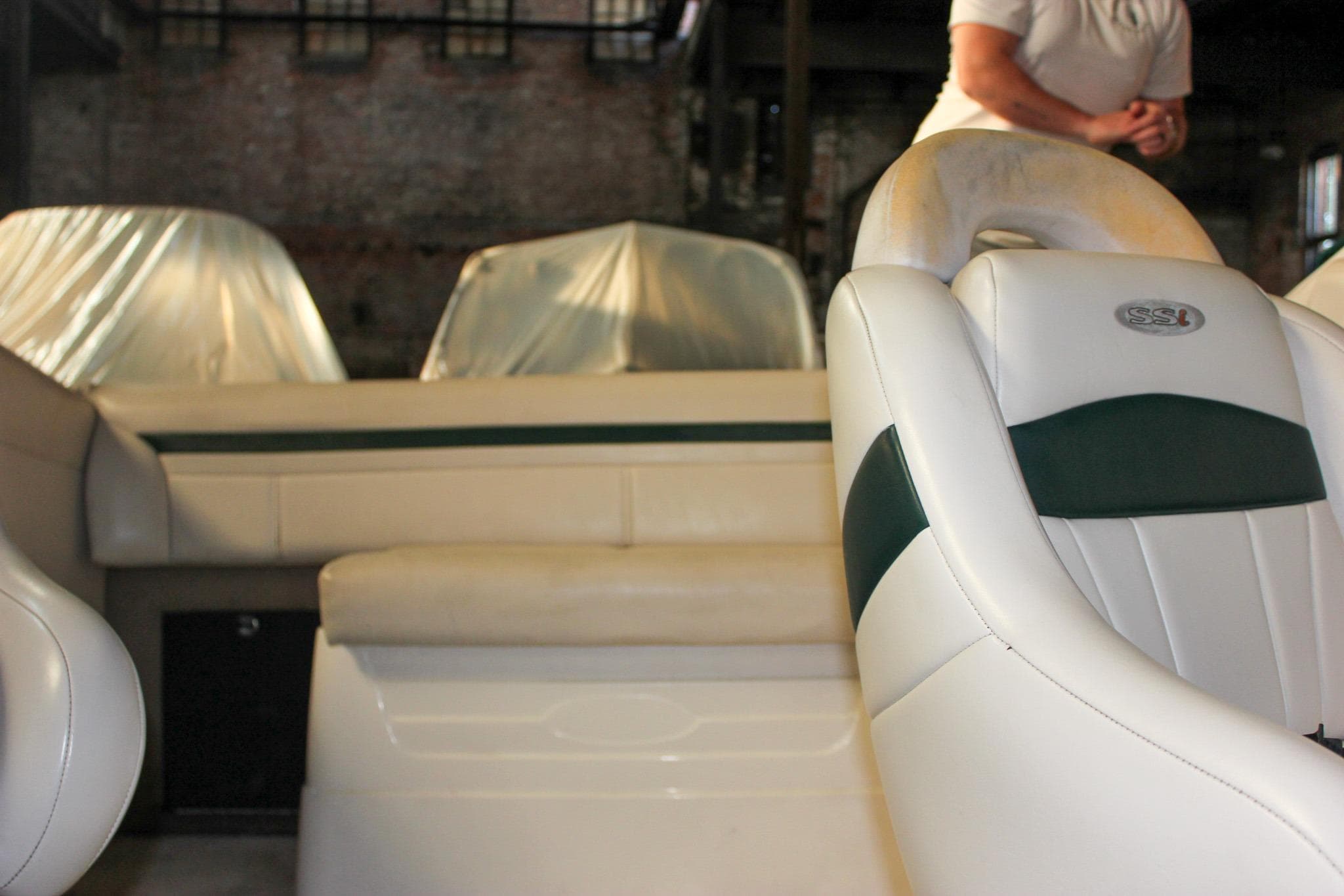 Interior of a 2000 Chaparral 245 SSi boat with white and green seating.