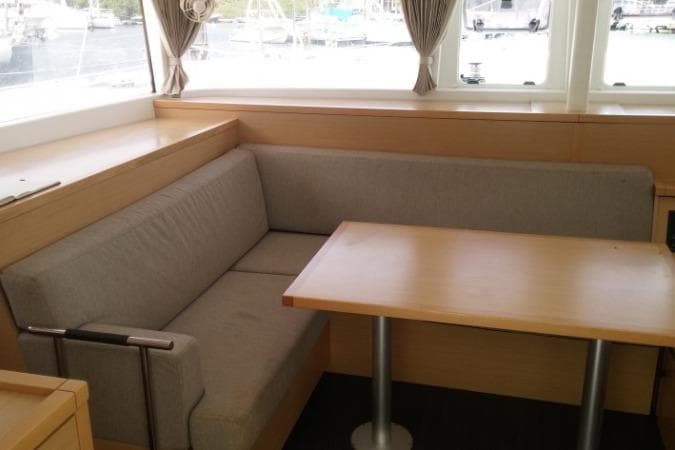 2018 Lagoon L400s2 yacht interior with cozy seating and wooden table.