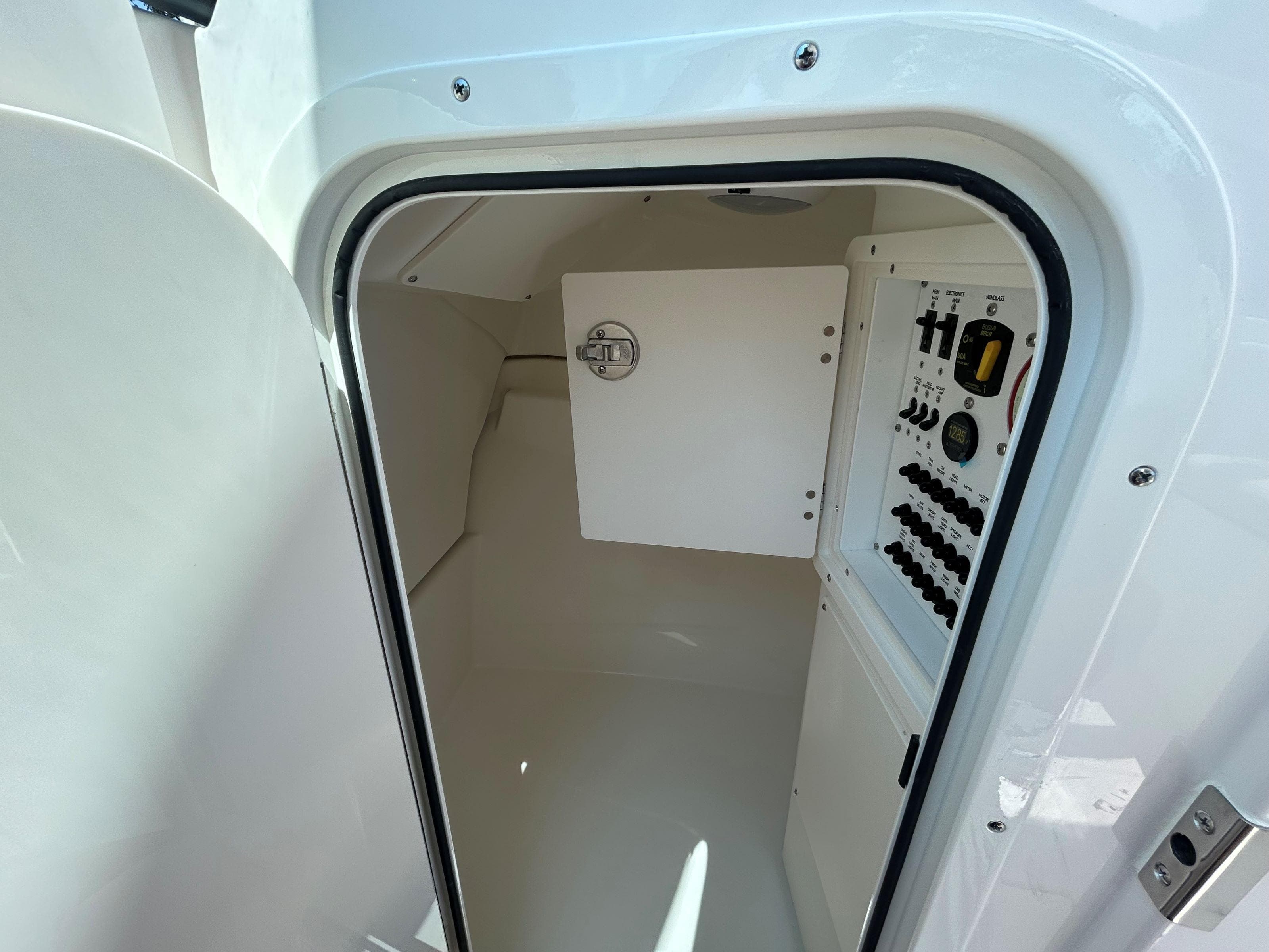 2026 Pursuit DC 246 Dual Console interior with control panel and storage compartment.
