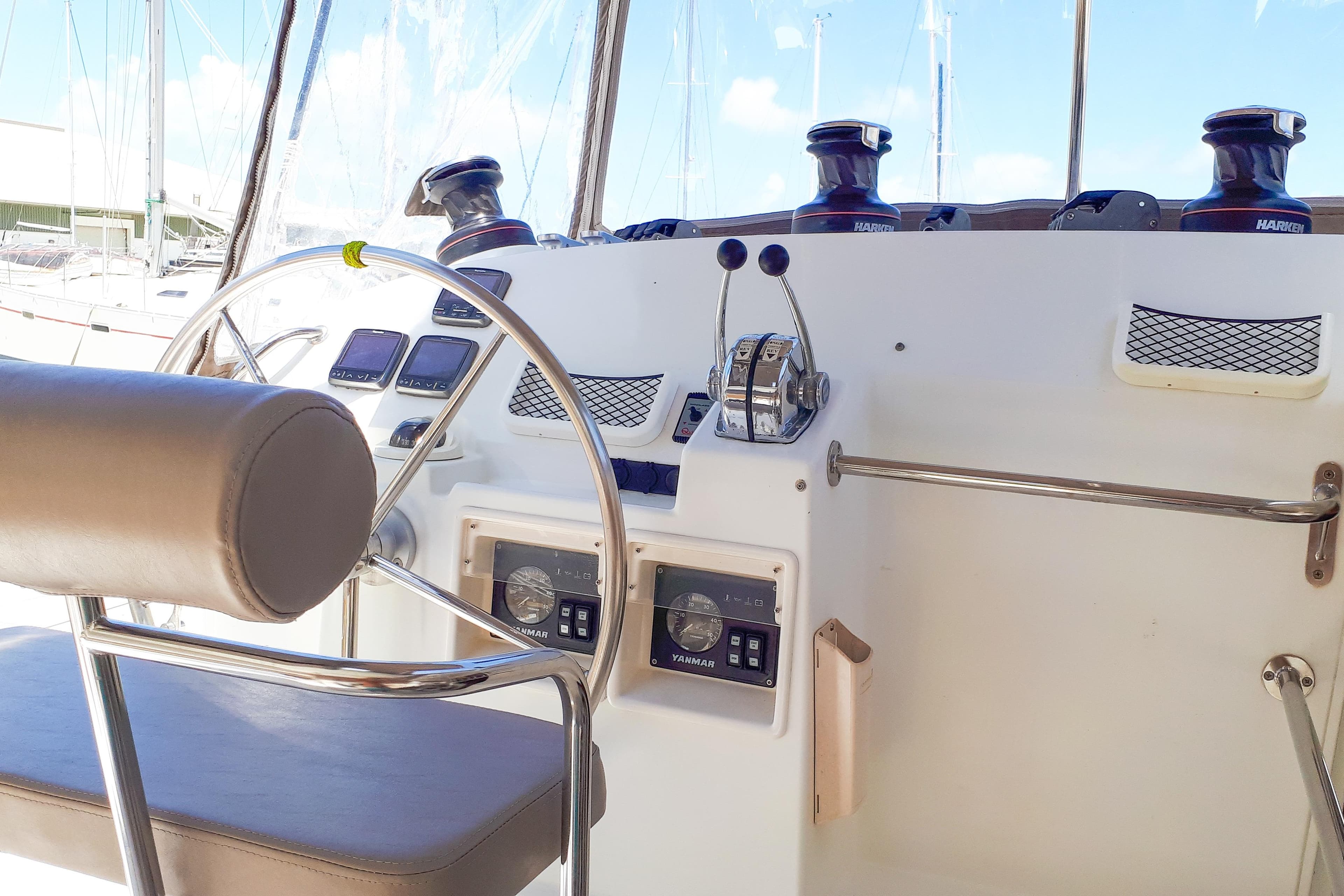 Helm of 2012 Lagoon 400 catamaran with steering wheel and navigation controls.