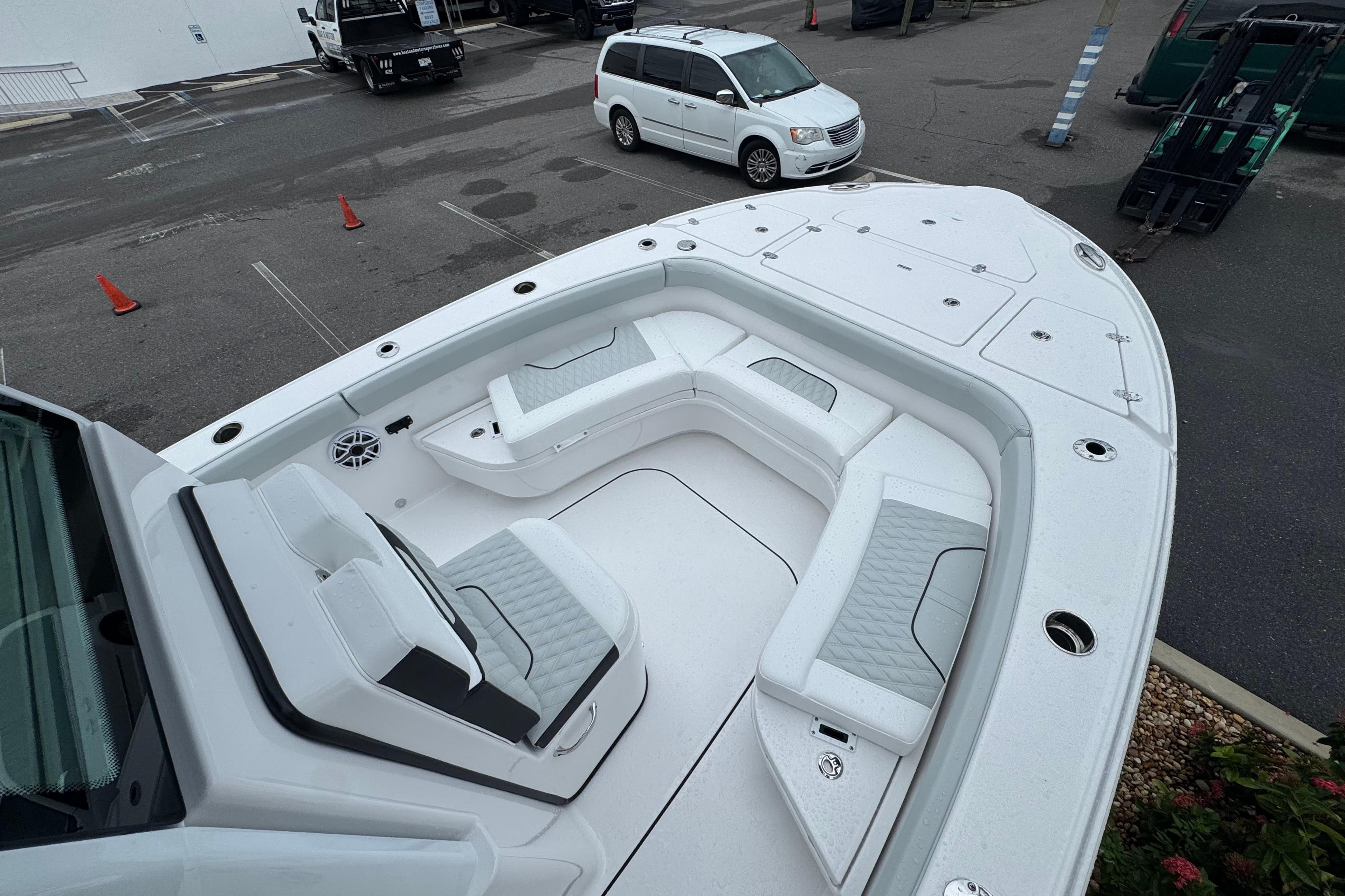 2026 Blackfin 262 HB boat with spacious seating and modern design in a parking area.