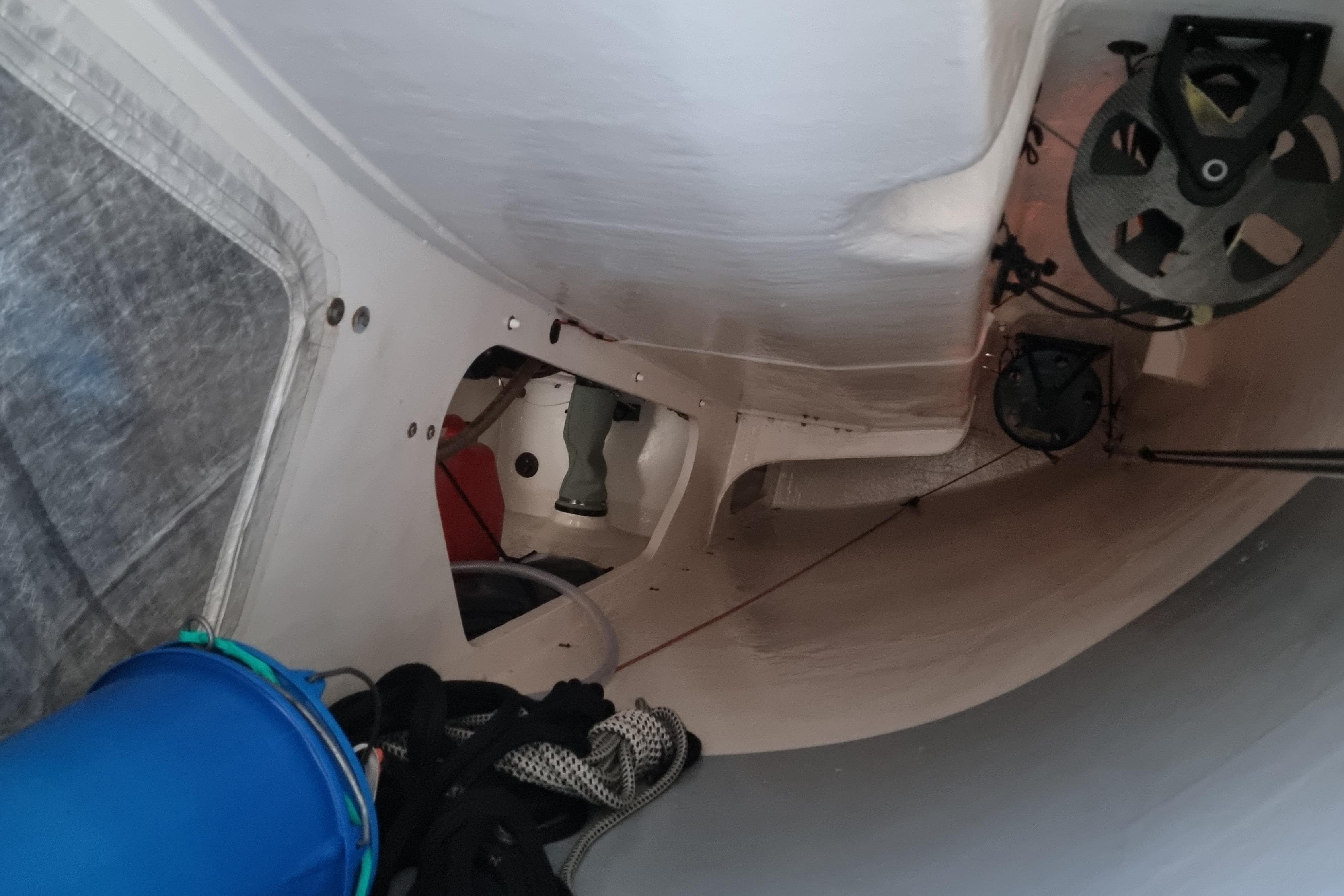 Interior view of 2022 One Design Cape31 sailboat, showcasing equipment and storage area.