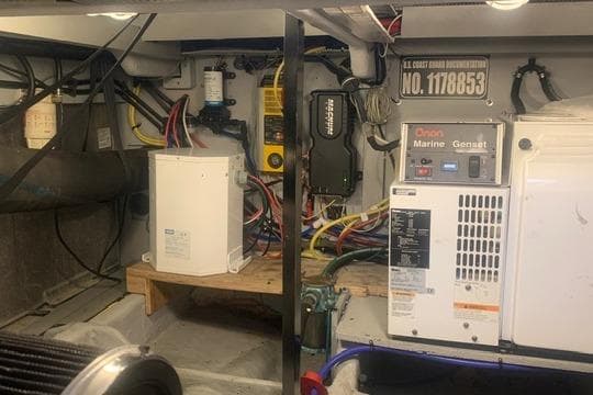 Engine room of a 2006 Meridian 411 Sedan with marine generator and electrical components.