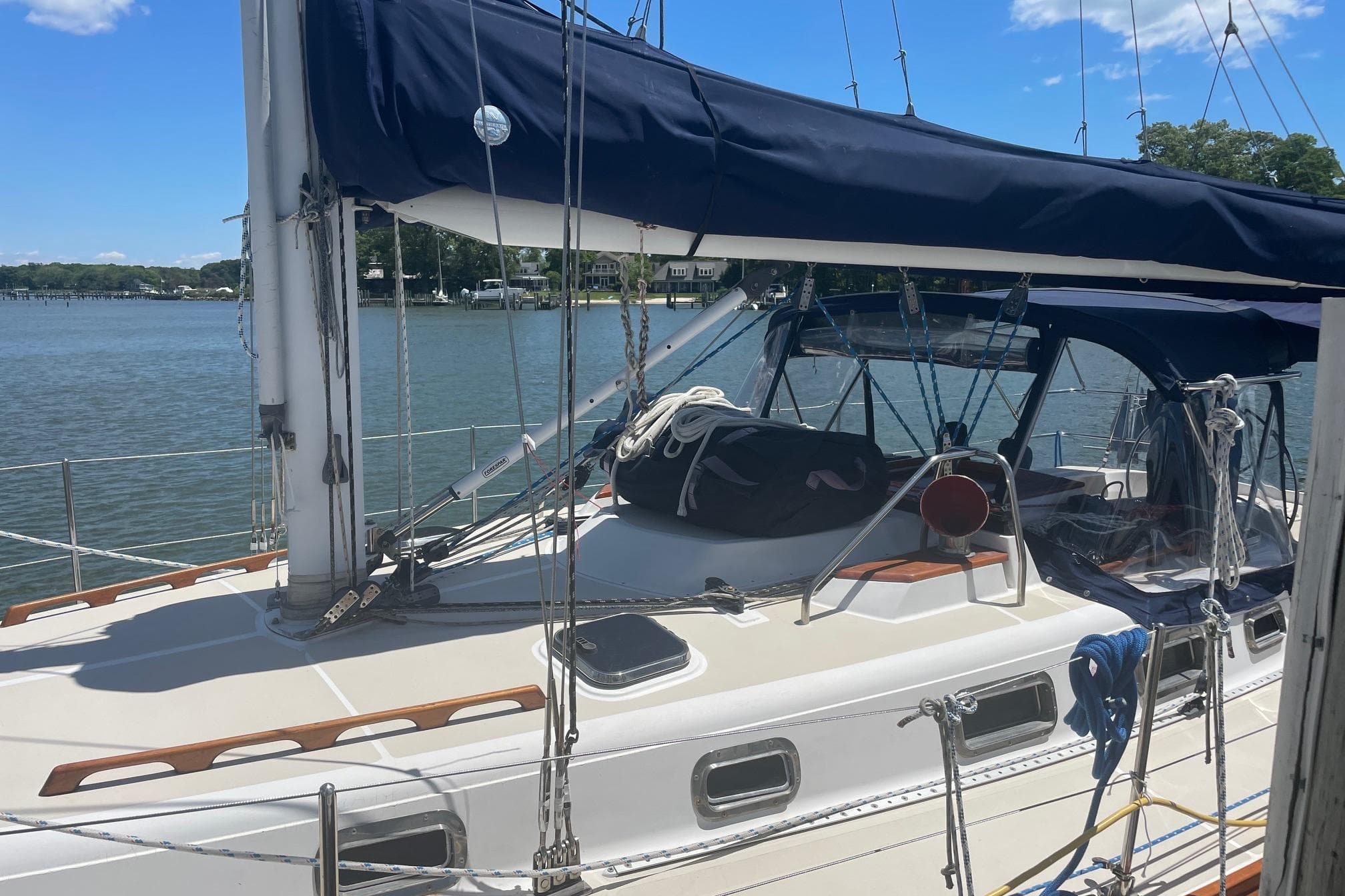 Sailboat Tartan 3700, 2001 model, docked by a serene waterfront.