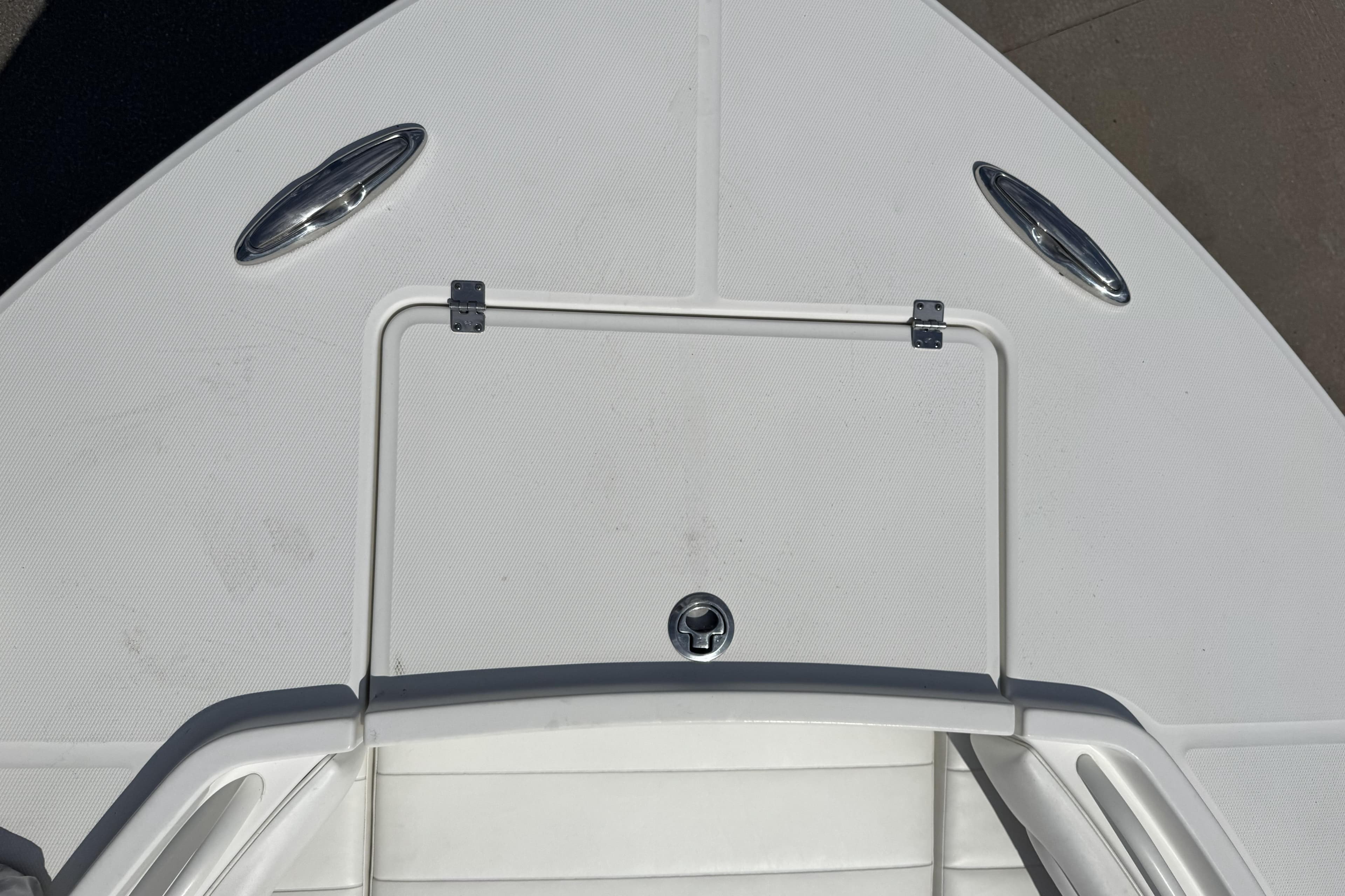 Bow of a 2018 Regulator 34SS boat with storage hatch and cleats.
