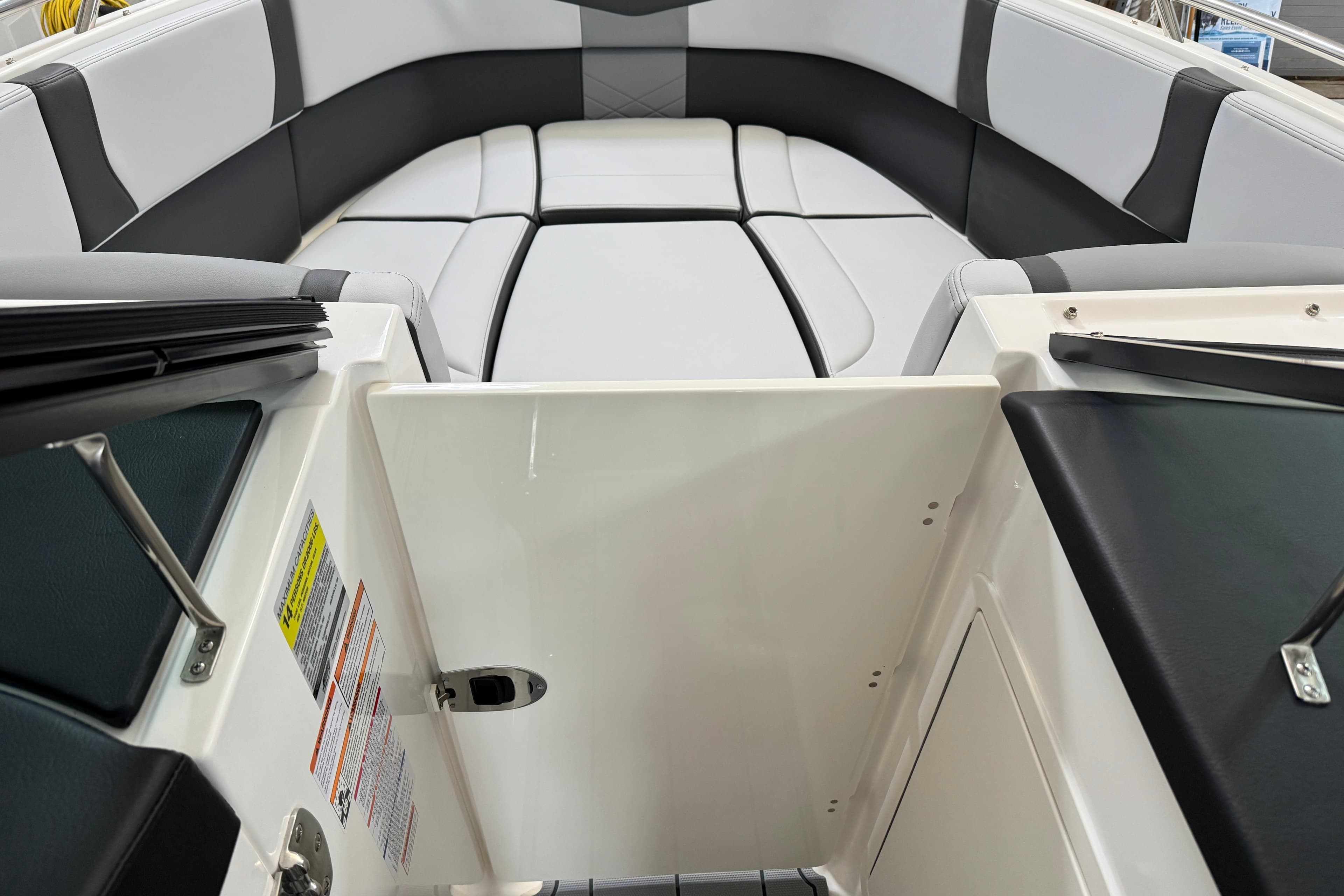 2026 Chaparral 270 OSX boat interior with sleek seating and open storage compartment.