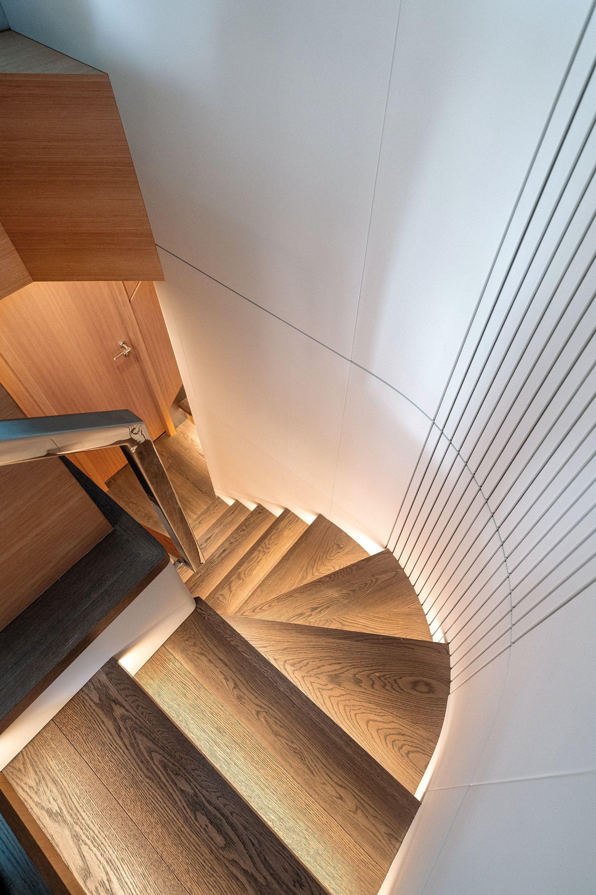 Spiral staircase in 2024 CL Yachts CLB72, featuring elegant wood and modern design.