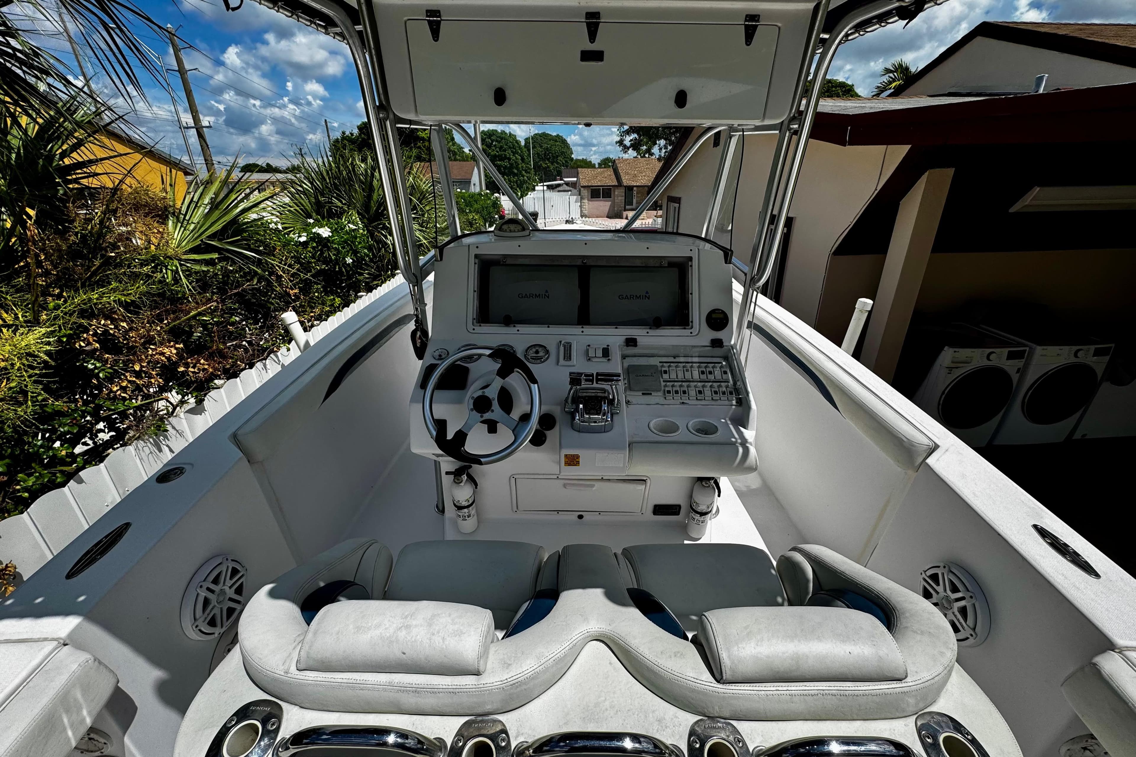2006 Donzi 32 ZF boat cockpit with steering wheel and navigation system.