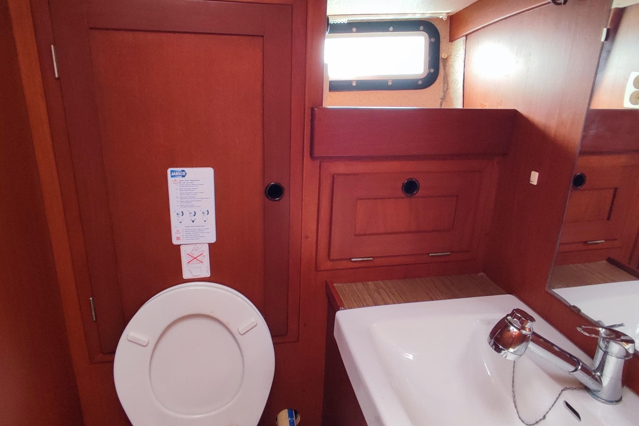 Hallberg-Rassy 352 yacht bathroom with wooden cabinetry and sink, 1982 model.
