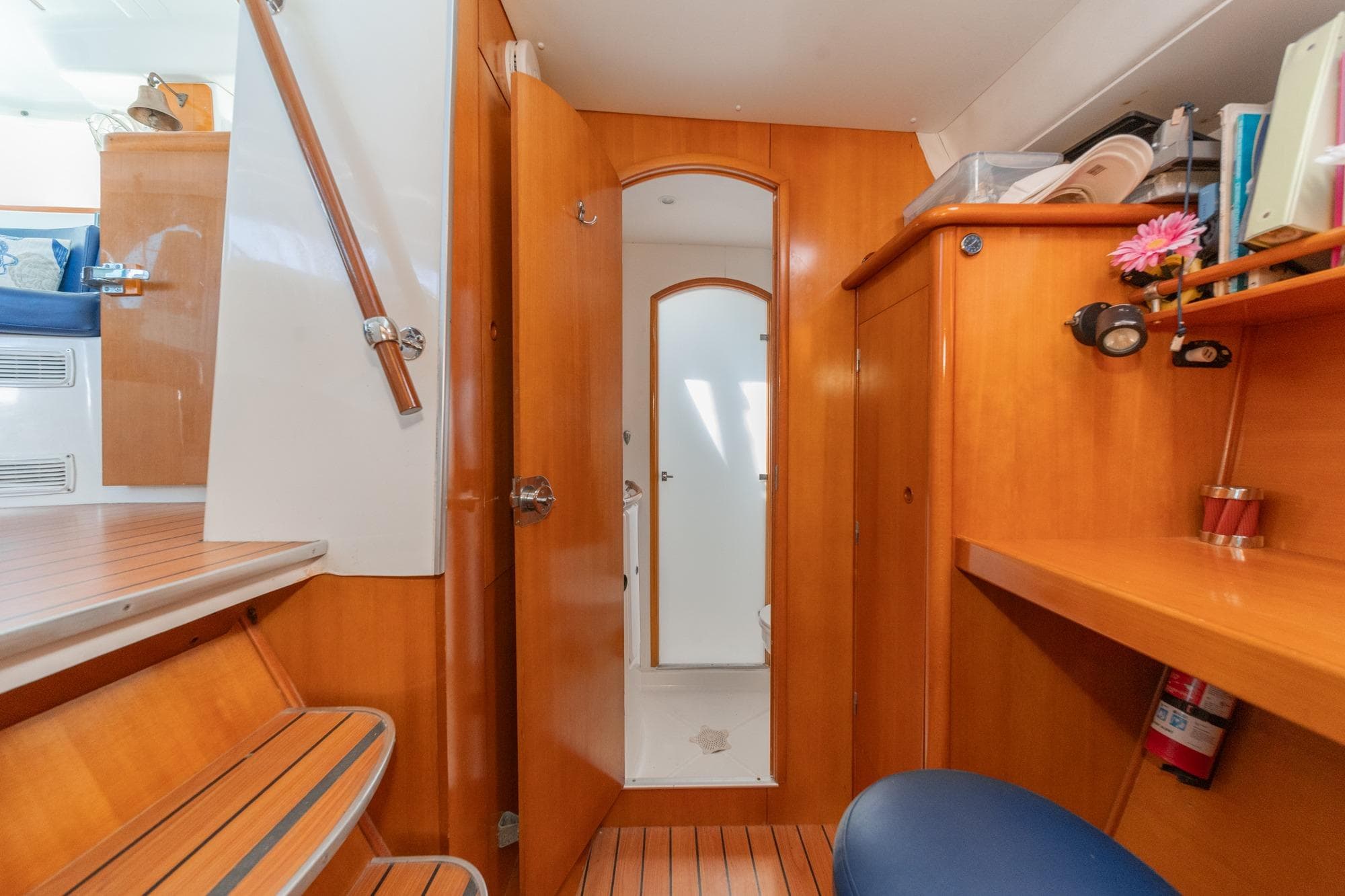 Interior of 2004 Lagoon 380 catamaran with wooden cabinetry and seating area.