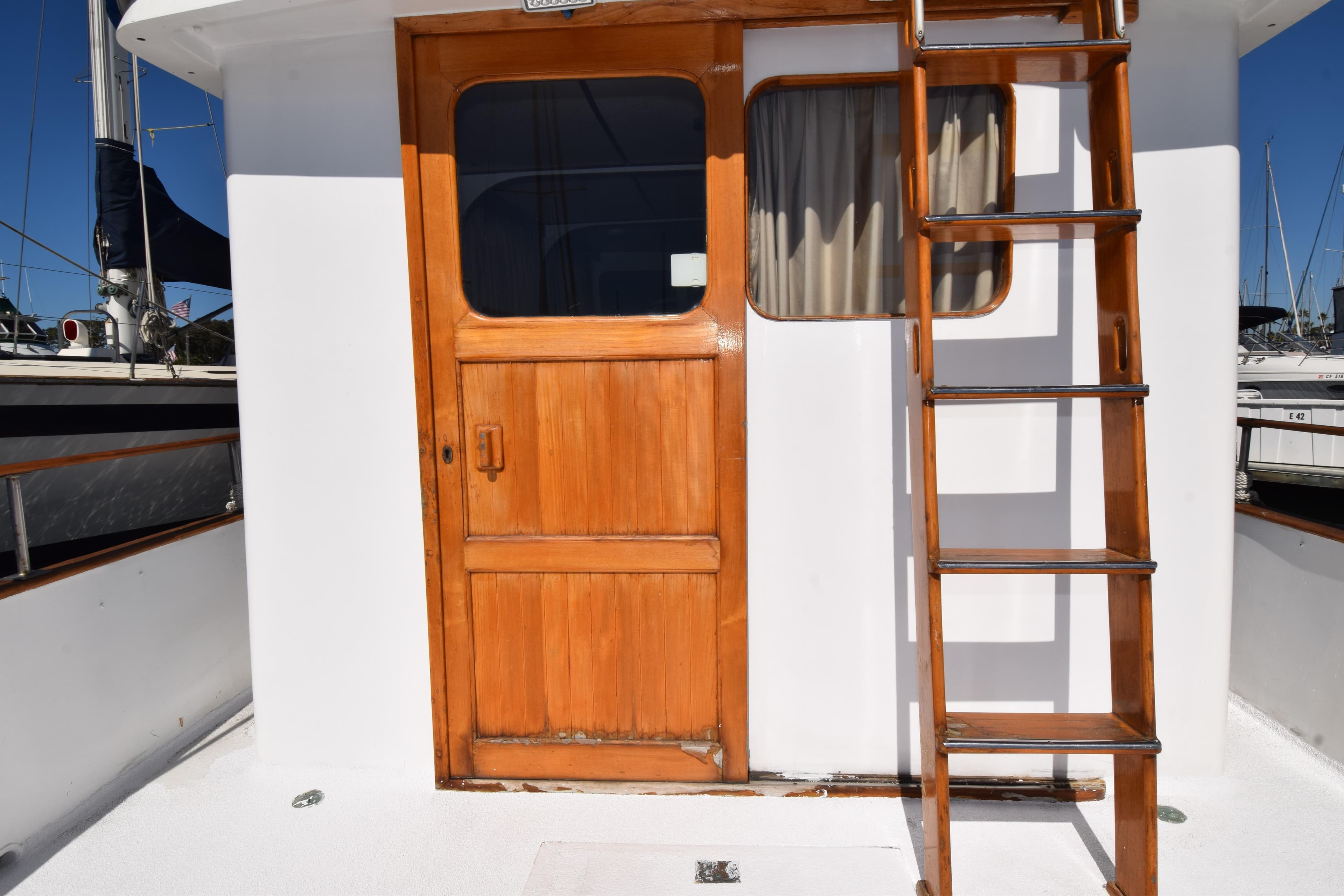 Wooden door and ladder on a 1972 CHB 34 boat deck.