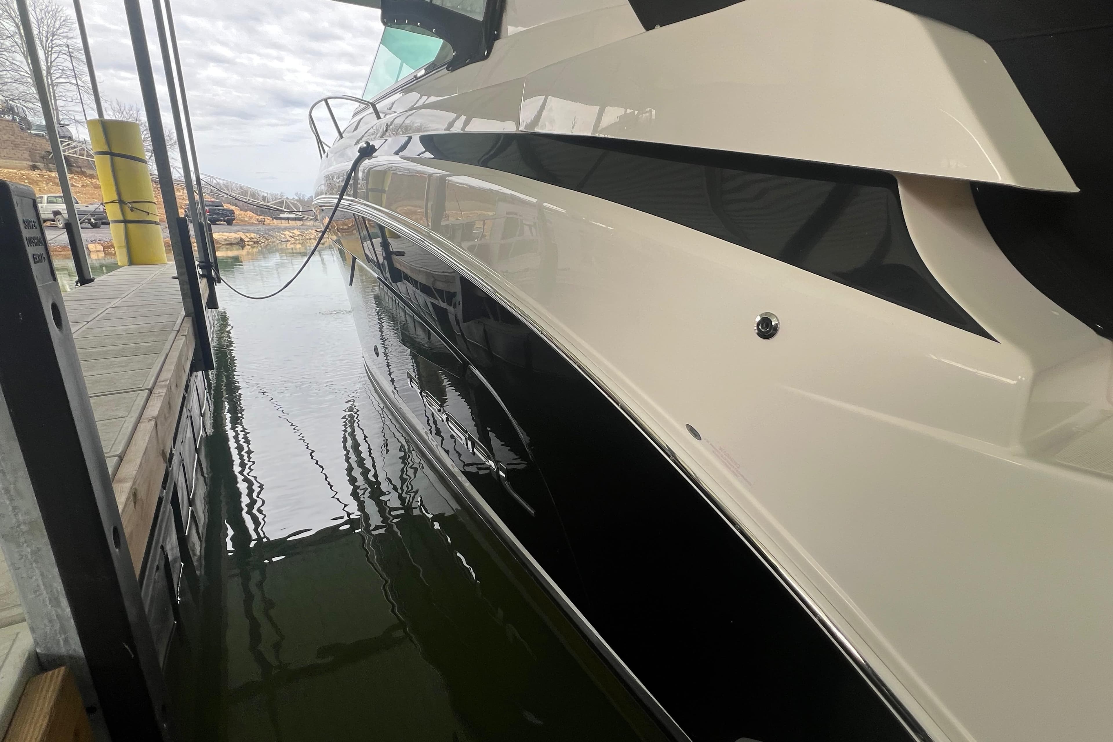 2019 Regal 33 Express yacht docked, showcasing sleek black and white hull design.