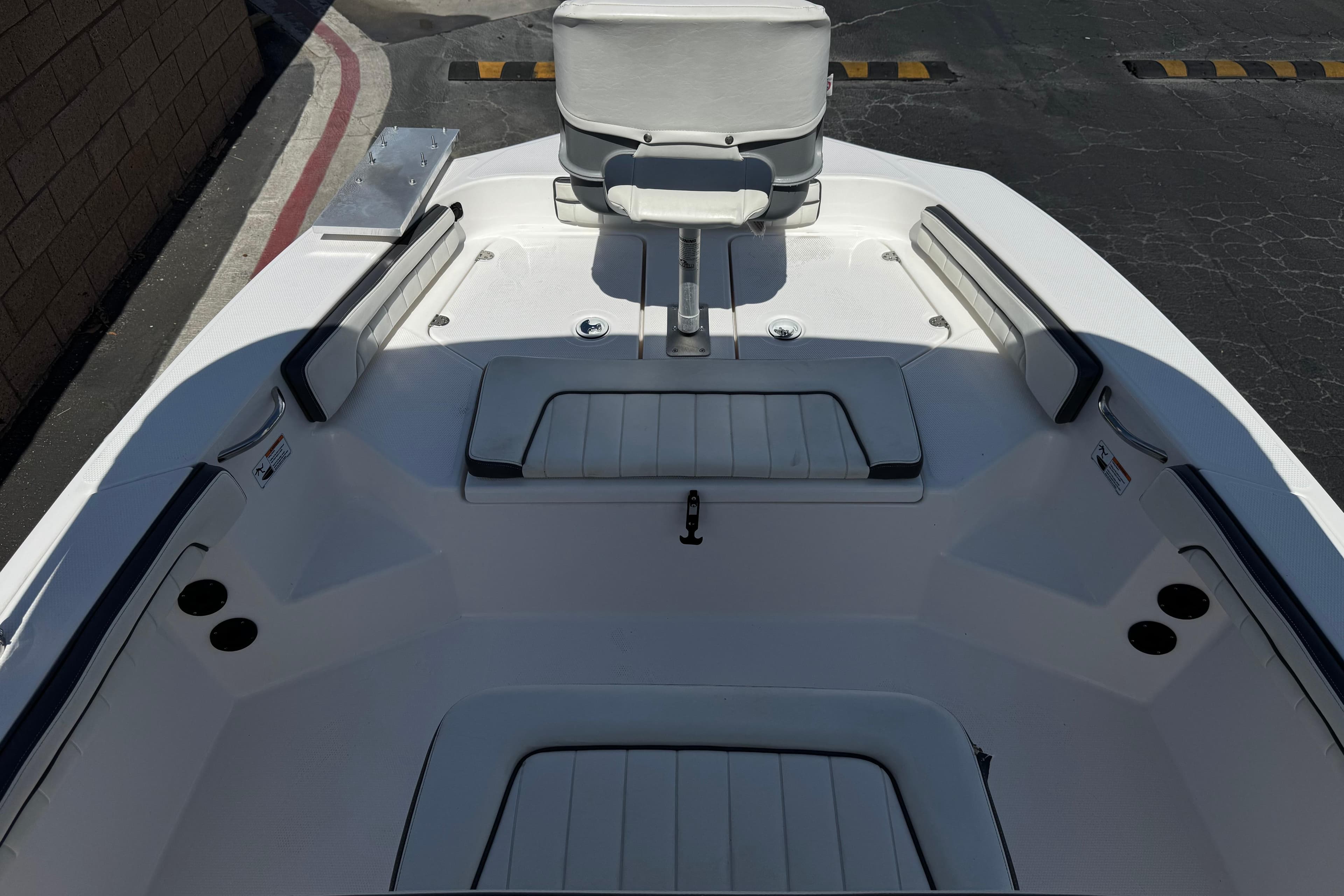 2016 Yamaha Boats 190 FSH Deluxe interior with seating and storage compartments.