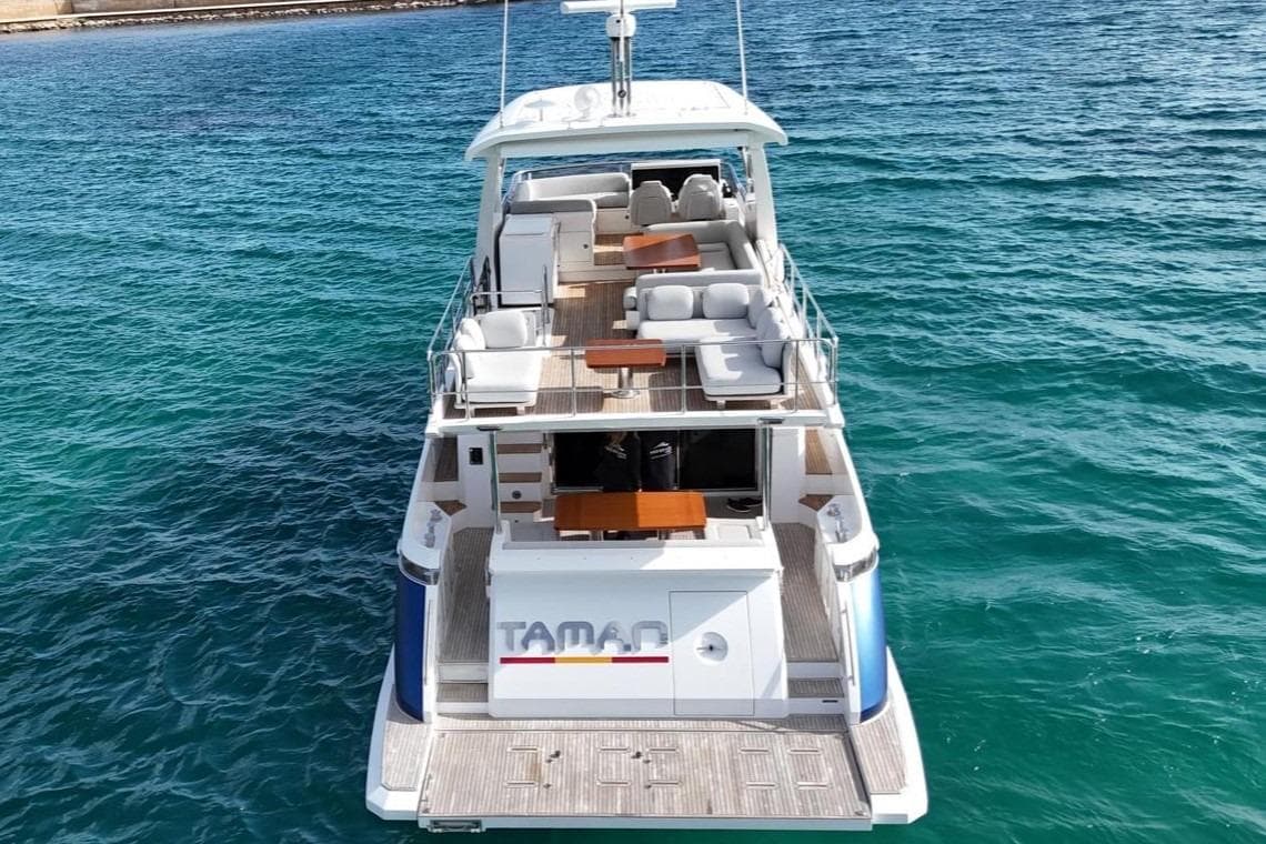 2021 Azimut 66 yacht on clear blue water, showcasing luxurious deck and seating area.