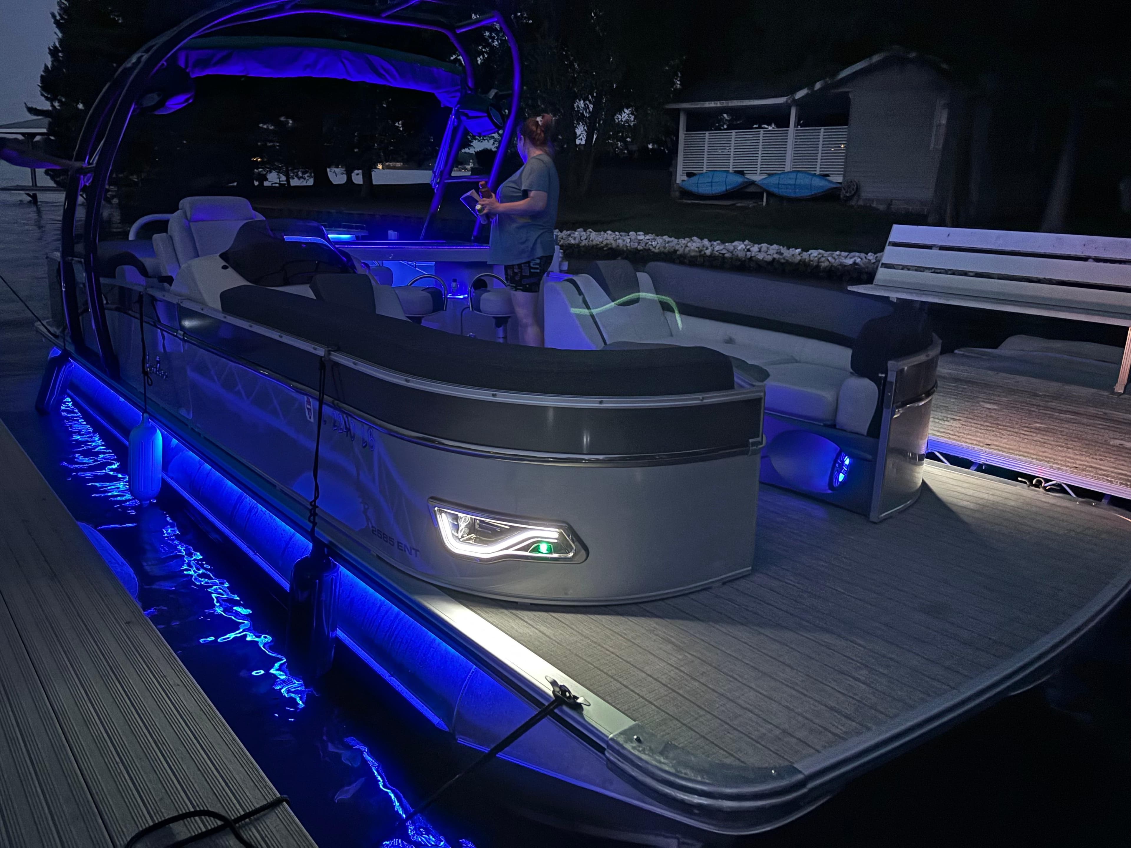 2021 Avalon Catalina Entertainer pontoon boat with blue LED lights at dock.
