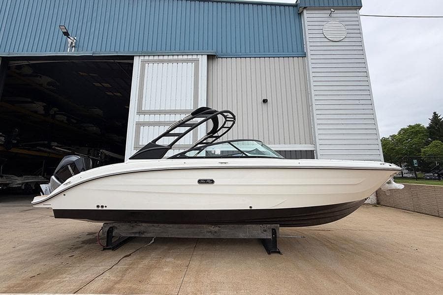 2026 Sea Ray SDX 270 Outboard boat displayed outside a large storage facility.