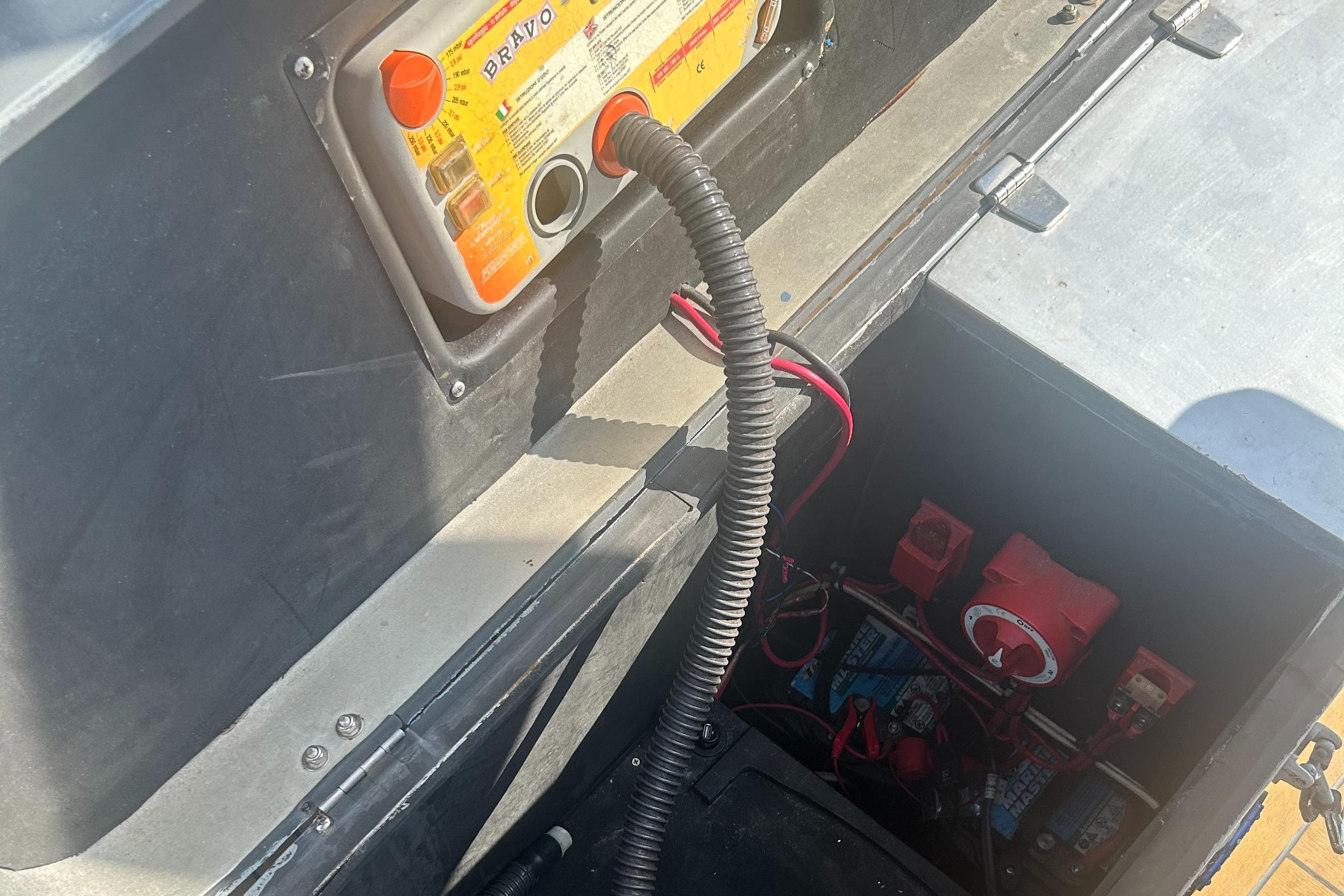 Electrical components inside a 2008 RIB U-23 Carbon Hull boat, featuring wiring and battery setup.