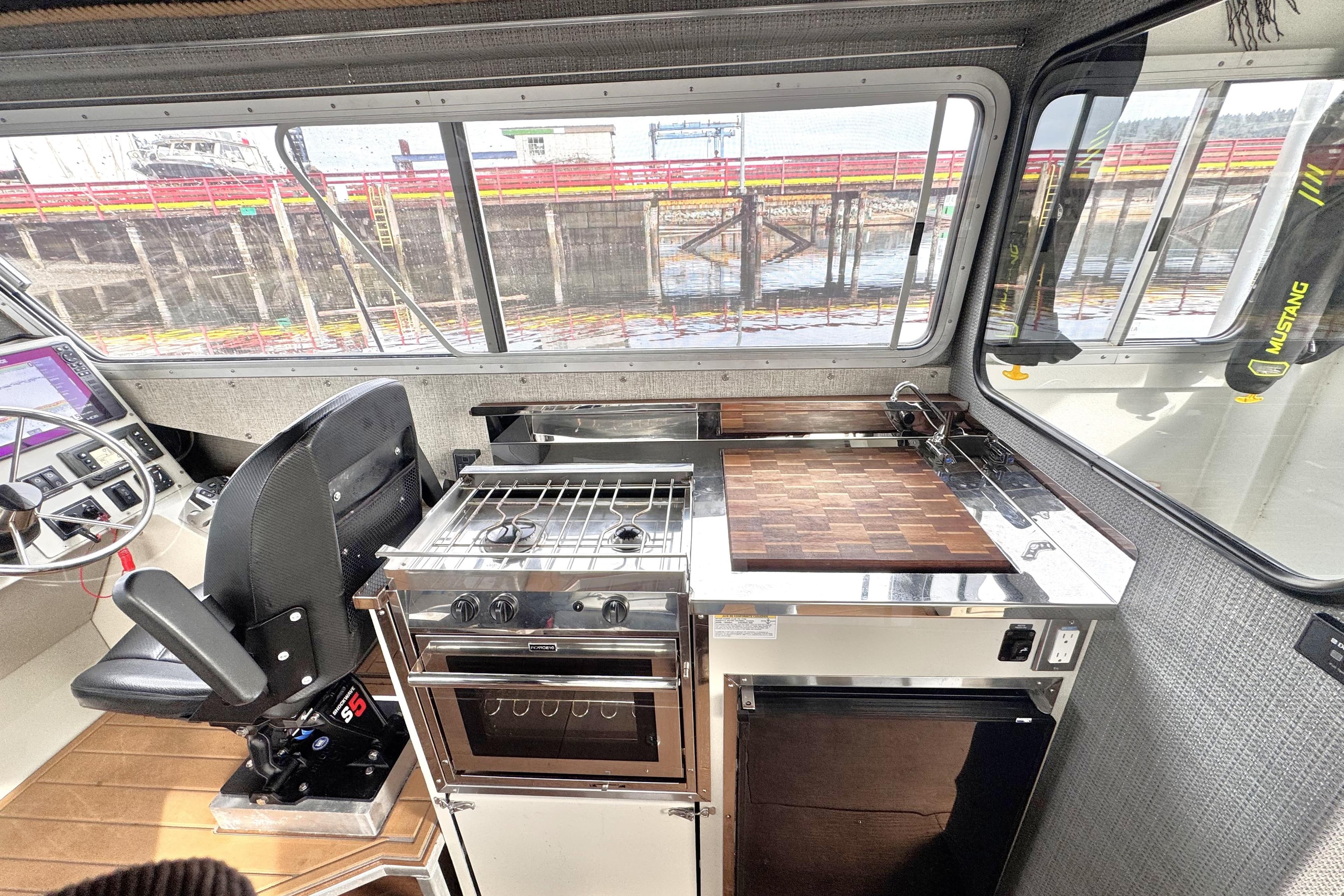 Interior of 2019 Riptide Marine Saratoga 35 Cruiser with kitchen and helm station.