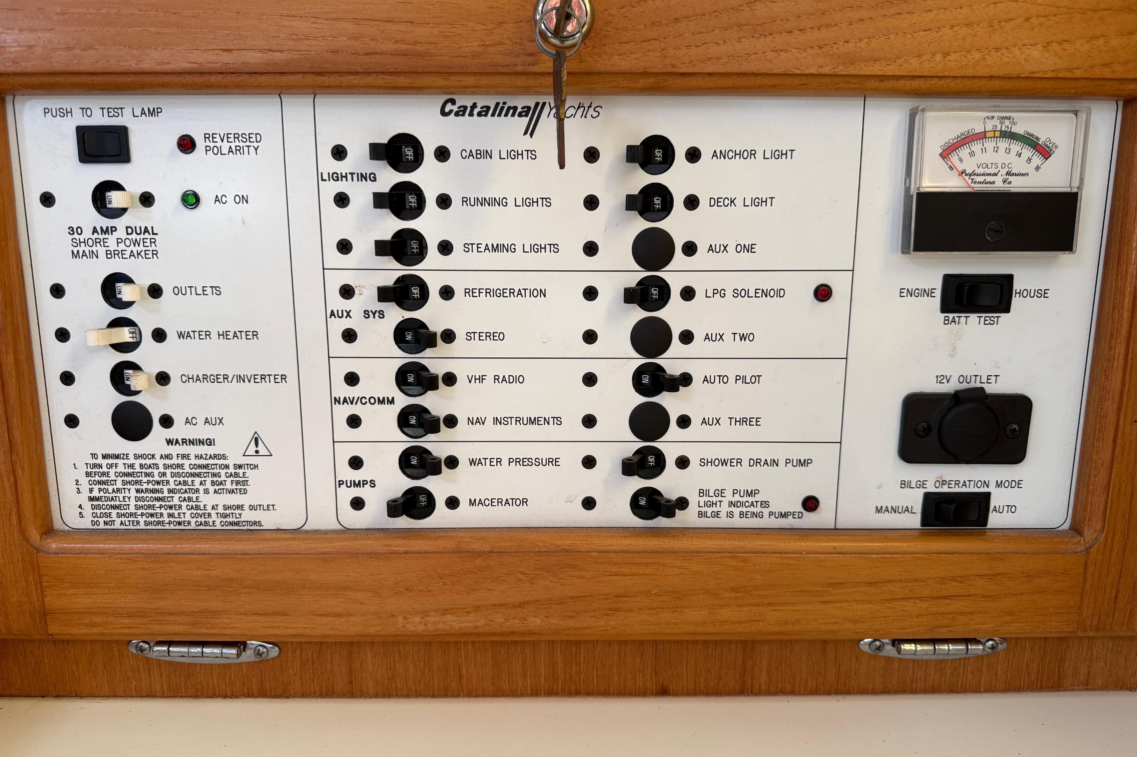 Electrical control panel of a 2000 Catalina 36 MkII yacht with various switches and gauges.