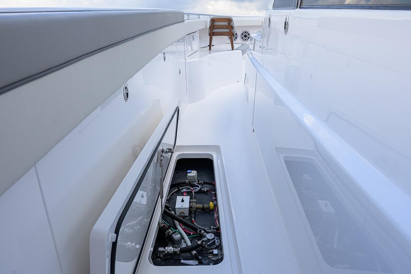 2026 Valhalla V-46 yacht deck with open storage compartment, showcasing sleek design.