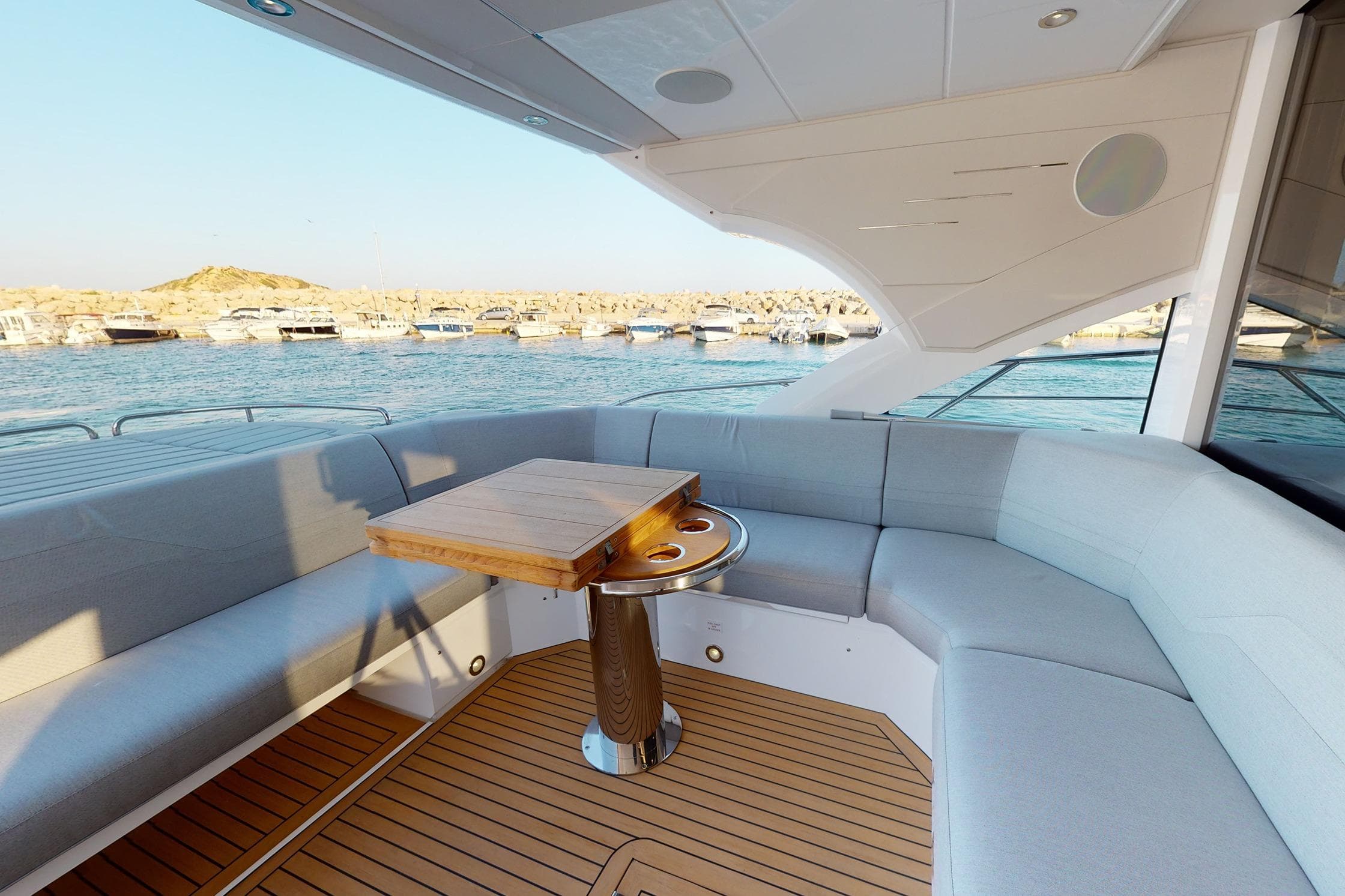 Luxurious Sunseeker Predator 60 EVO yacht interior with elegant seating and wooden table, 2022 model.