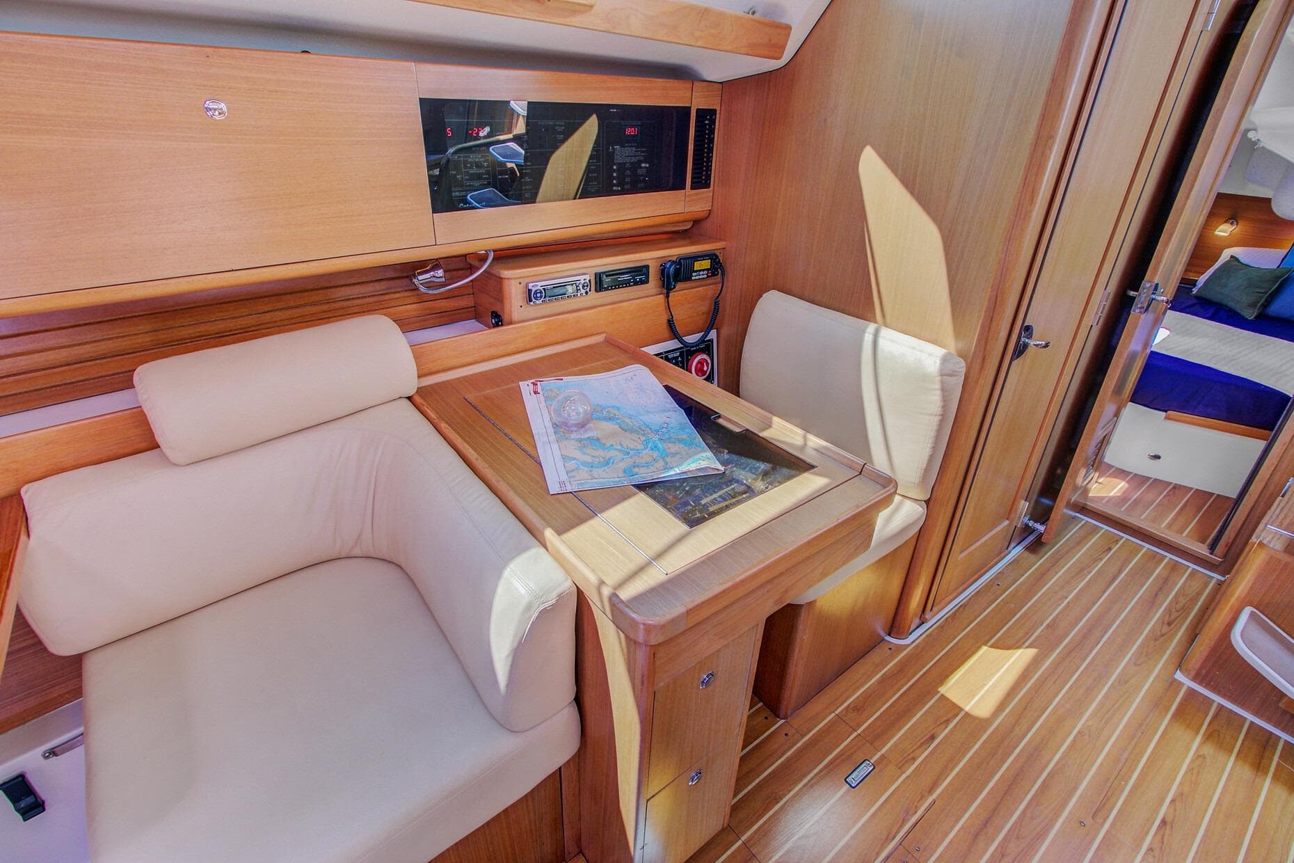 Luxurious interior of 2011 Catalina 445 sailboat with navigation table and seating.