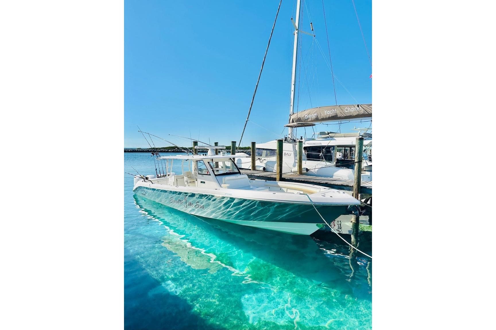 2016 Everglades 435 Center Console boat docked in clear turquoise water.