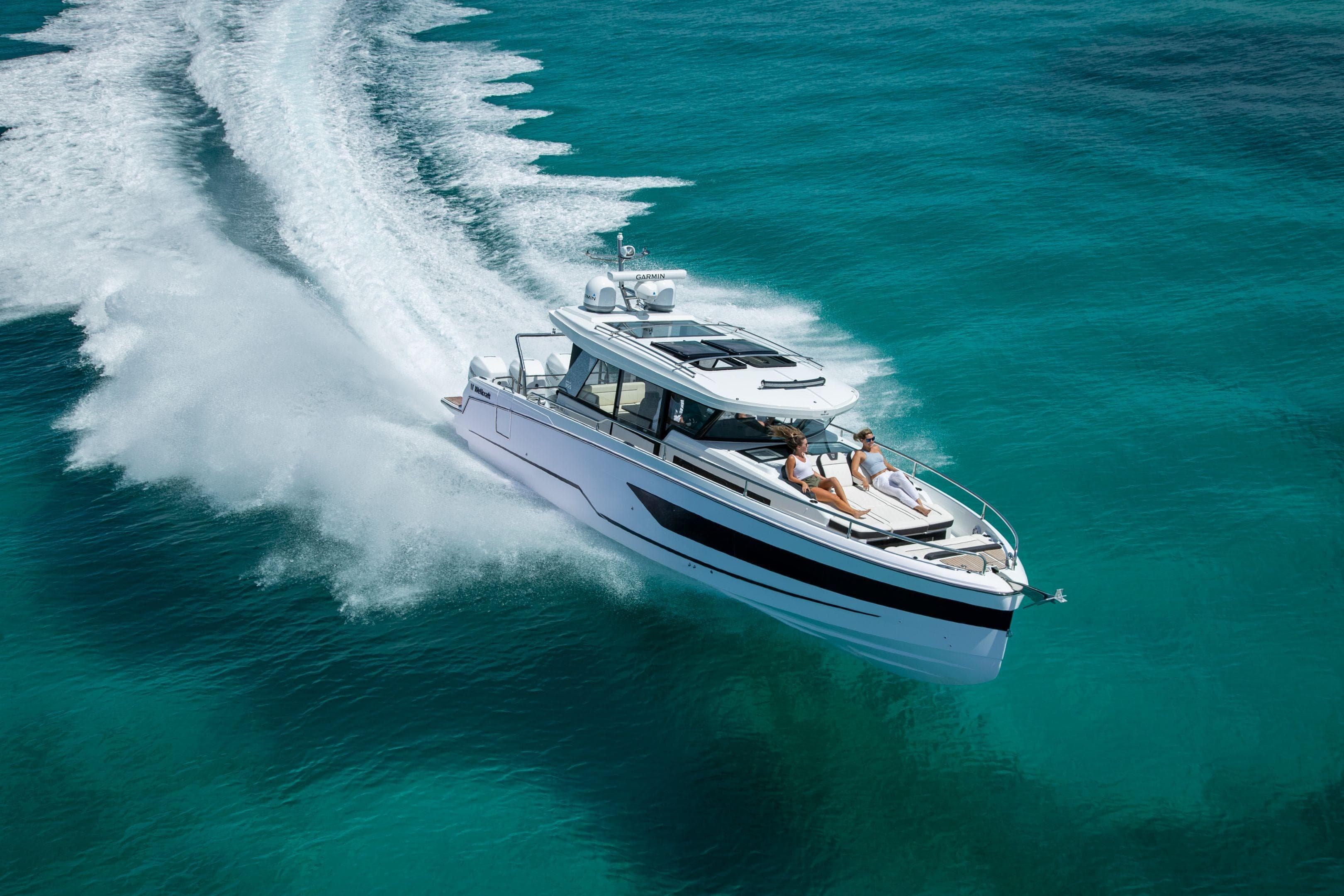 2026 Wellcraft 38 Explorer cruising on clear turquoise waters.