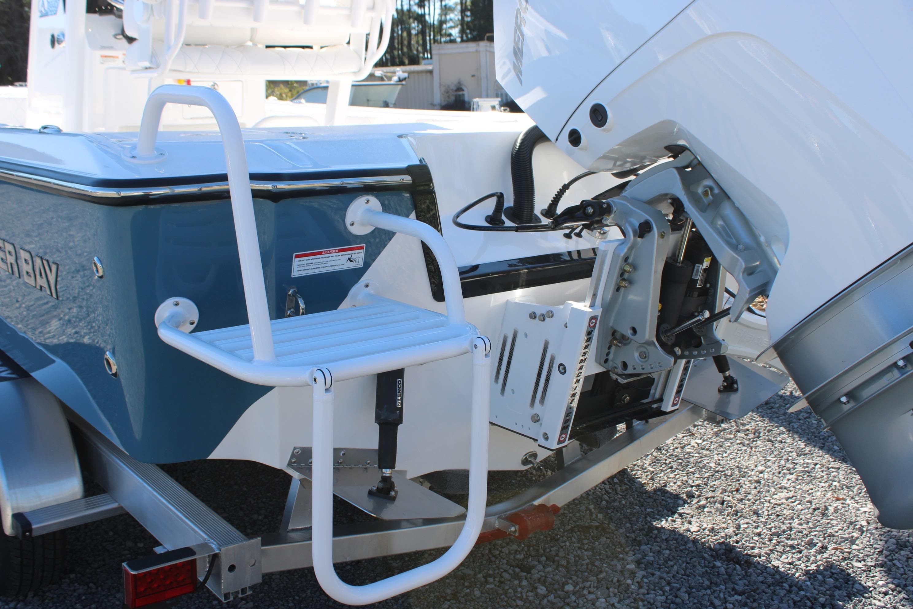 2026 Blazer Bay 2440 boat with motor and swim ladder on trailer.