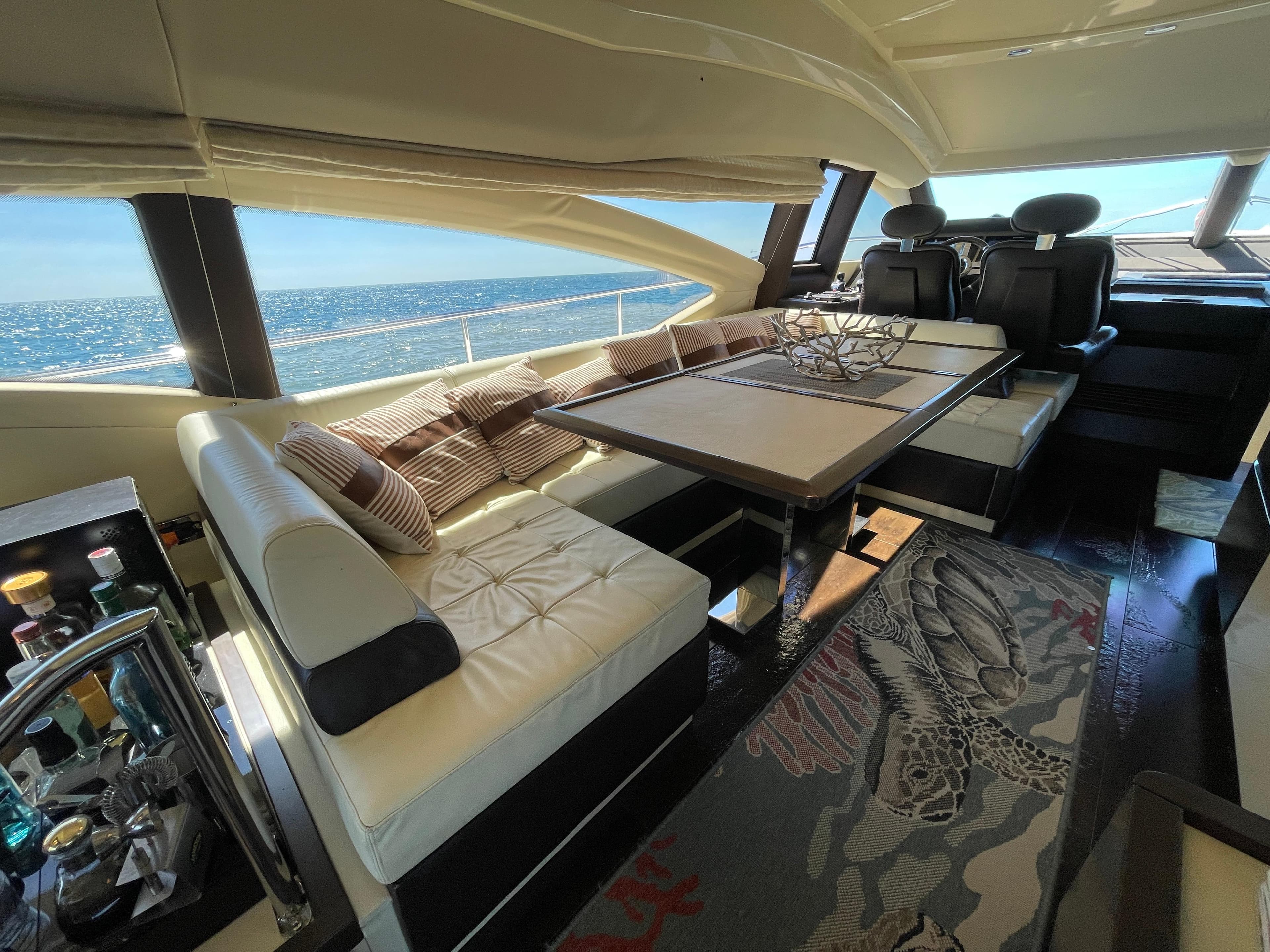 Luxurious interior of a 2014 Azimut 70 yacht with elegant seating and ocean view.