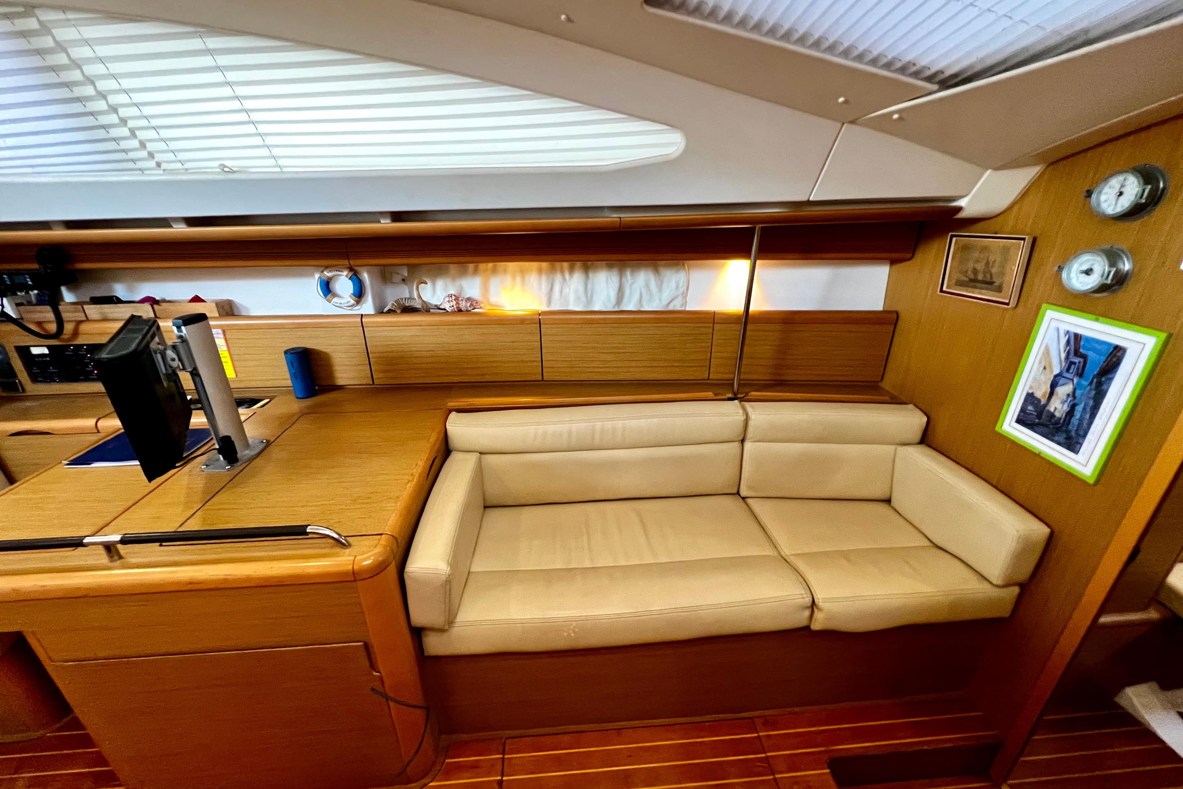 Interior of 2008 Jeanneau Sun Odyssey 45 DS yacht with beige seating and wooden accents.