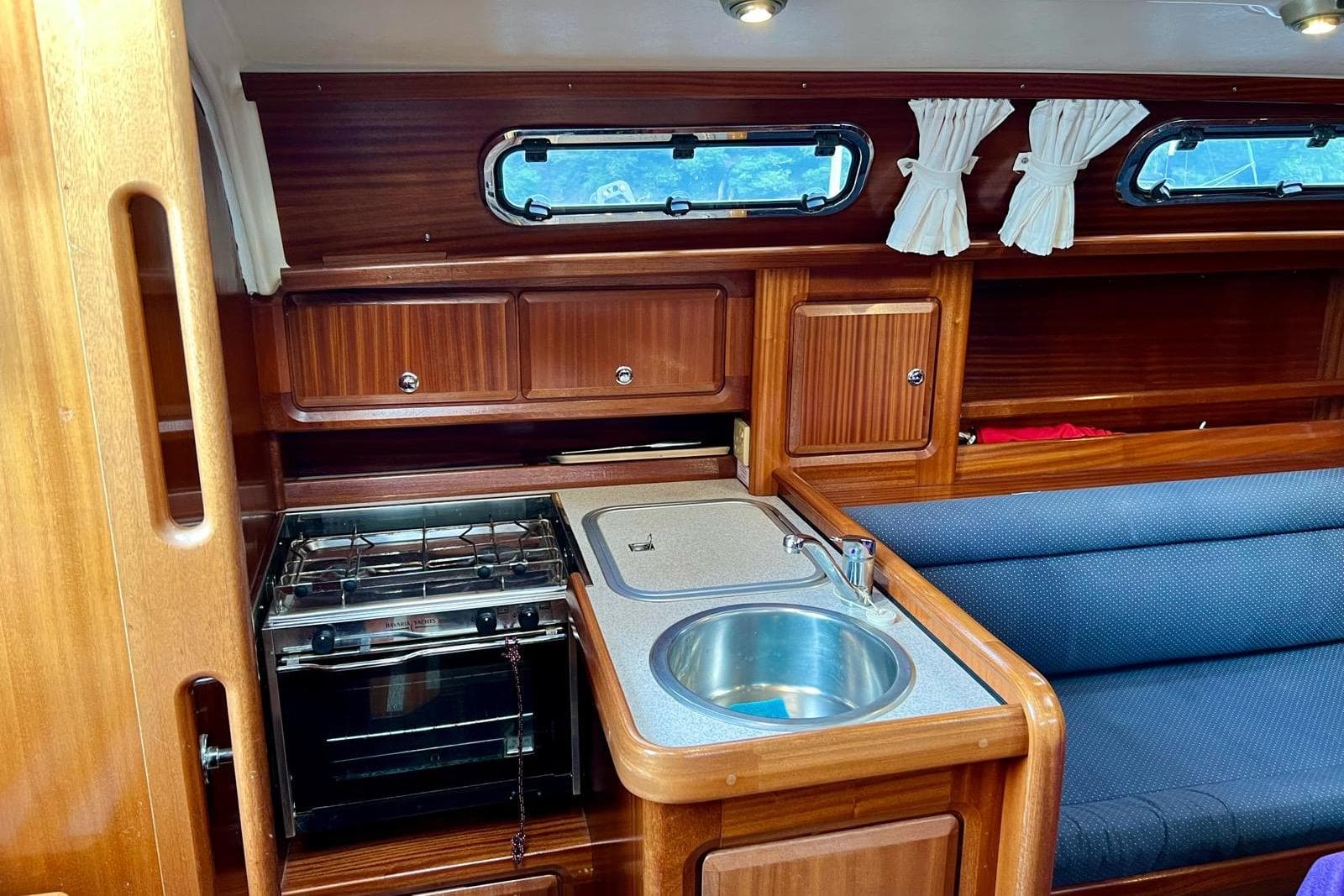 Interior of 2001 Bavaria 34 yacht with kitchen and seating area.