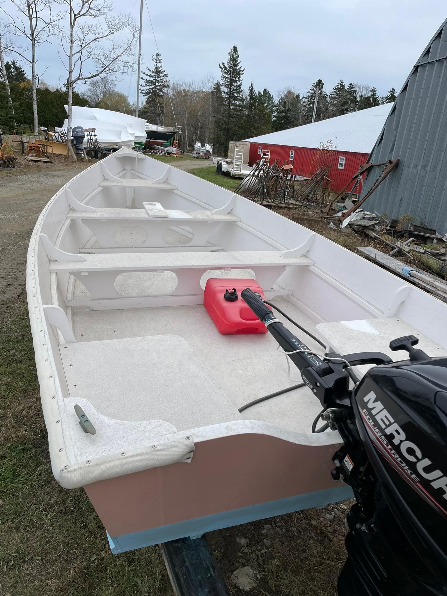 2017 Rossiter Estate Skiff with Mercury outboard motor, docked outdoors.
