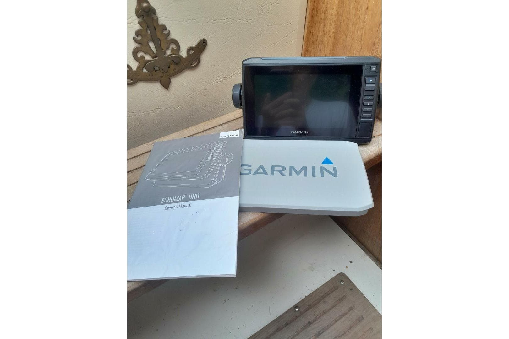 Garmin ECHOMAP UHD device and manual on a 1986 Catalina 34 sailboat.