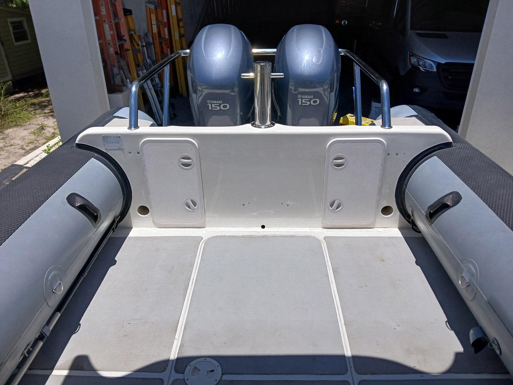 Rear view of a 2002 Protector 28 Targa boat with dual Yamaha 150 engines.