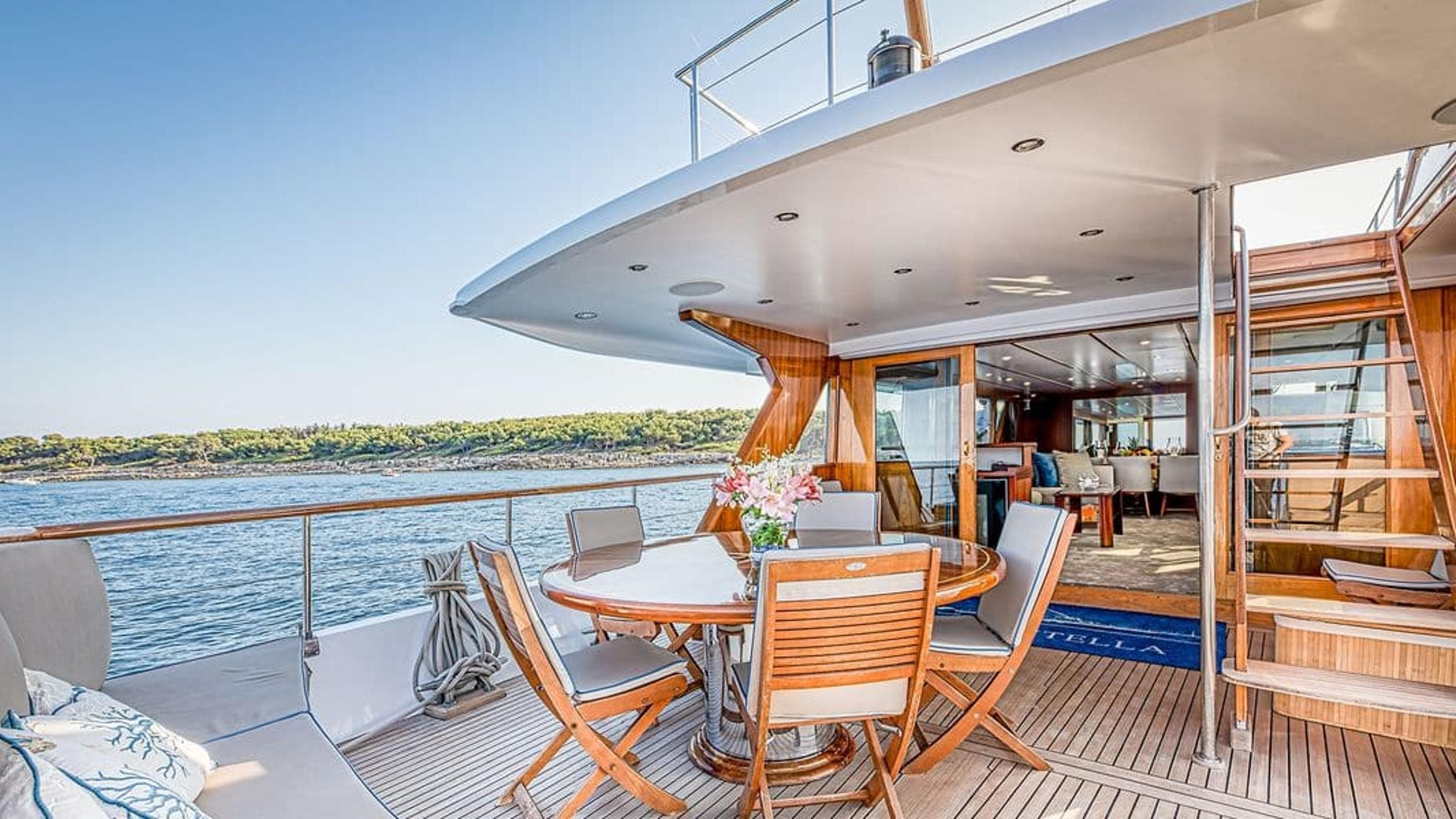 Luxurious 1966 Chantier de l’Esterel 28M yacht deck with elegant seating and scenic water view.