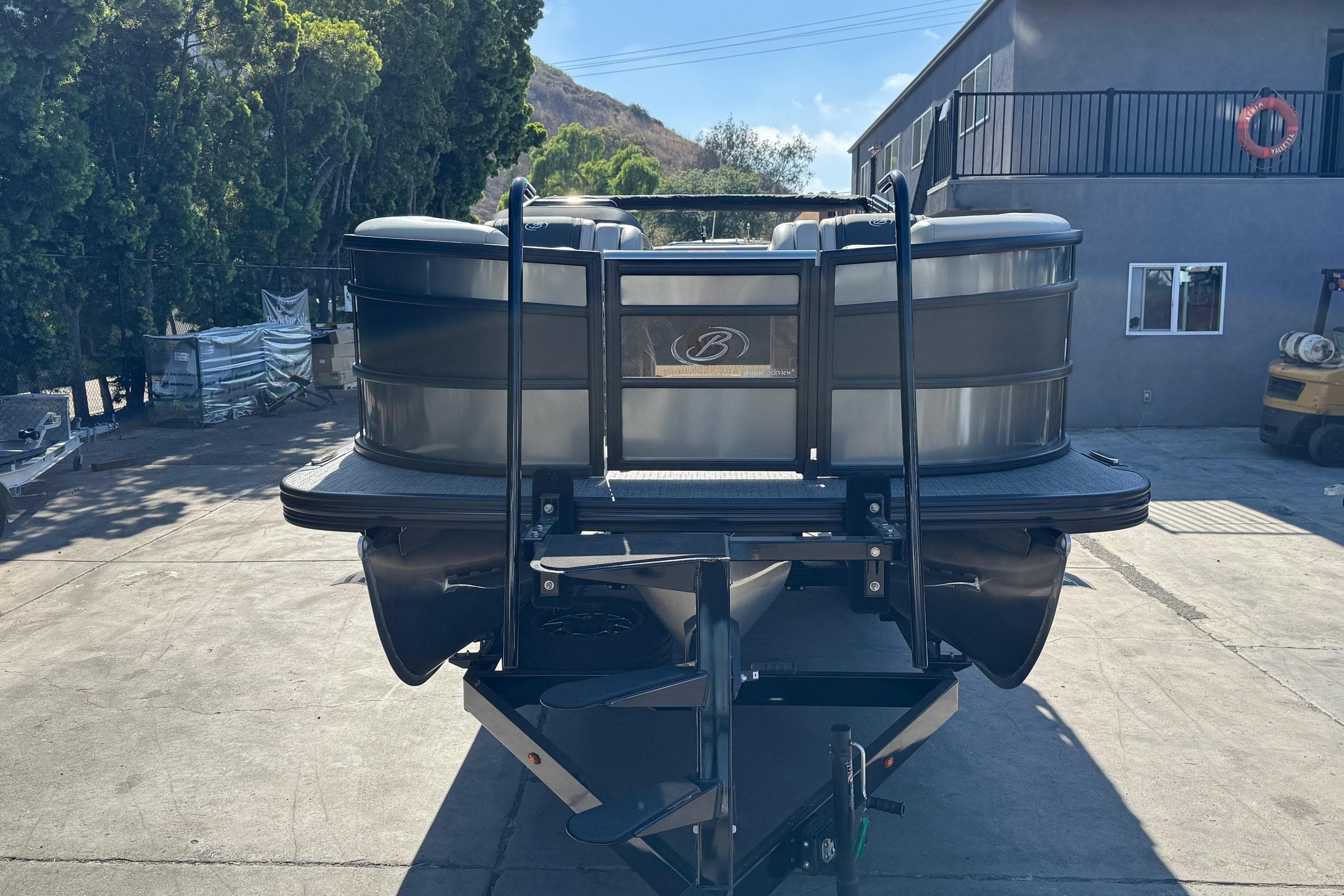 2026 Barletta Lusso 23UC pontoon boat parked outdoors, rear view.