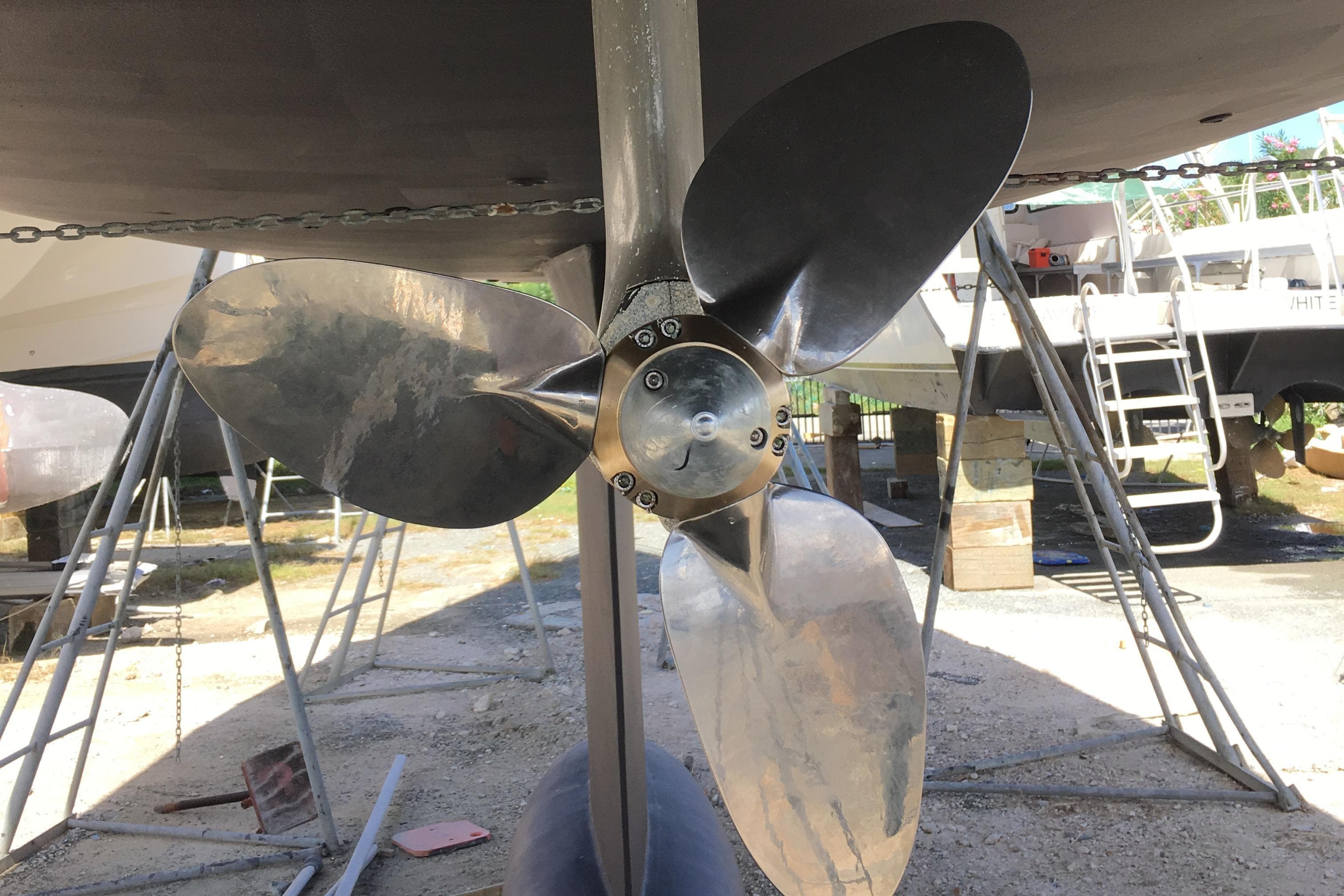 Propeller of 2016 Hanse 505 yacht on dry dock, surrounded by maintenance equipment.