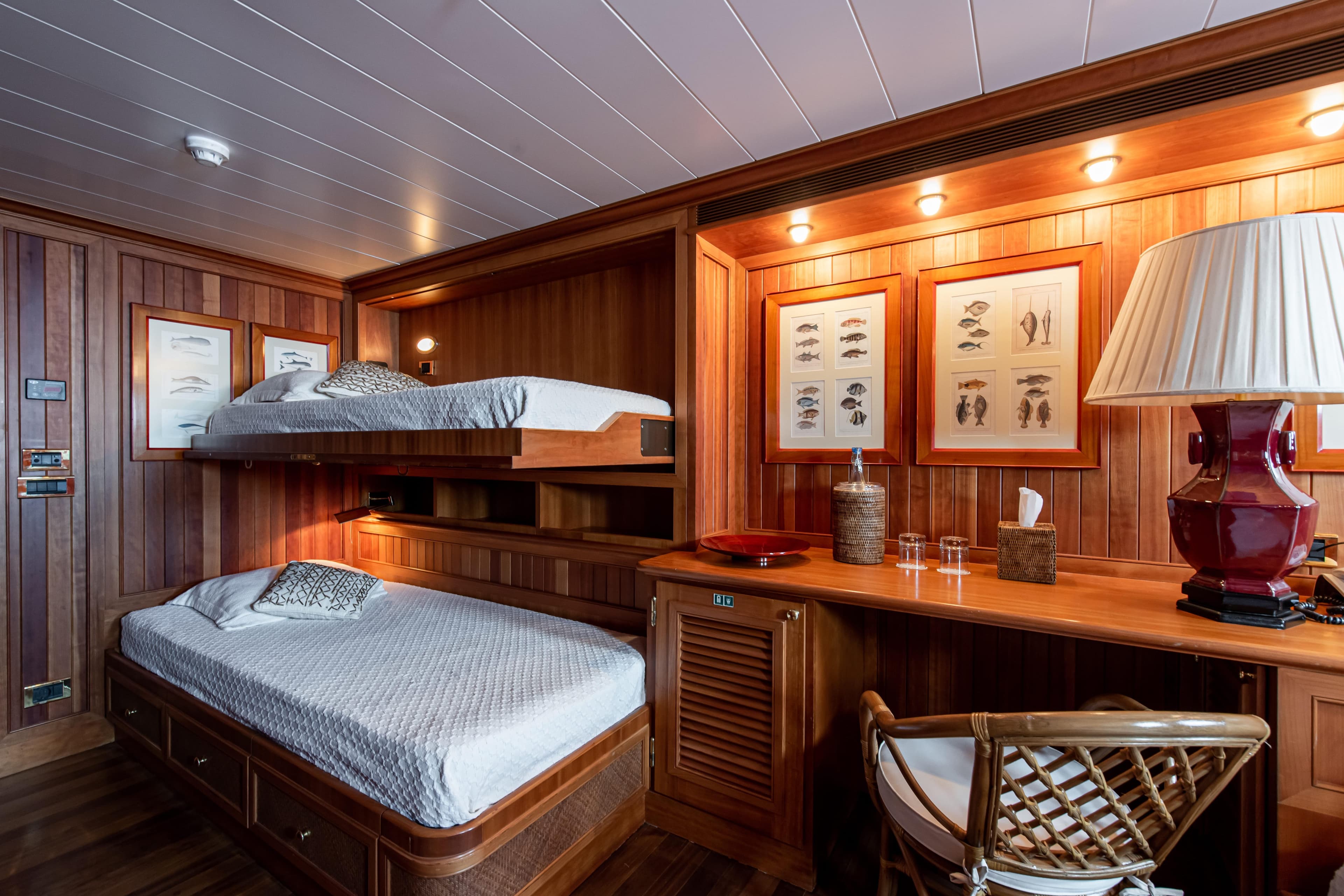 Cozy wooden cabin interior with bunk beds, nautical decor, and ambient lighting, 1980 custom conversion.