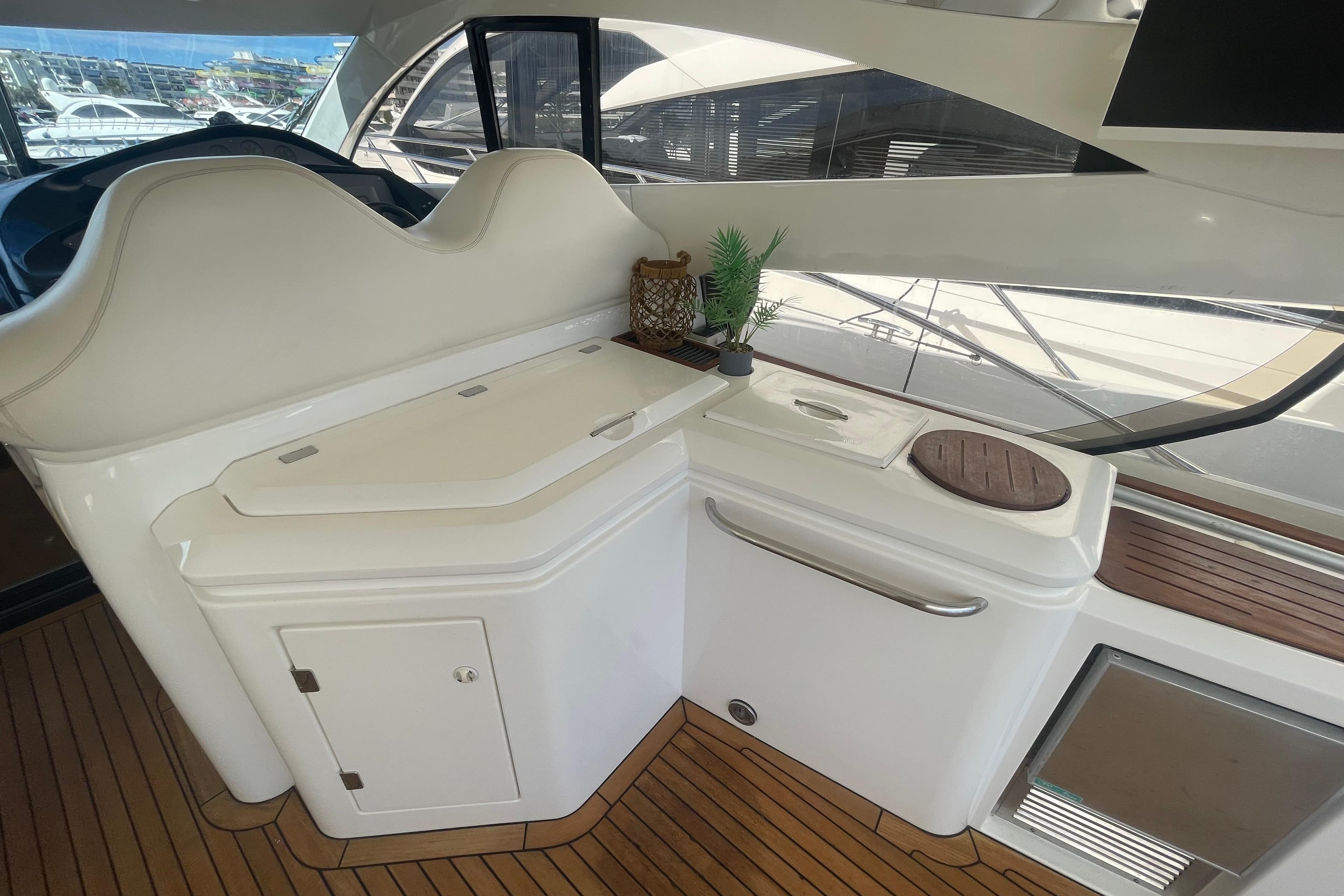Luxurious interior of 2003 Sunseeker Predator 68 yacht with sleek white cabinetry.