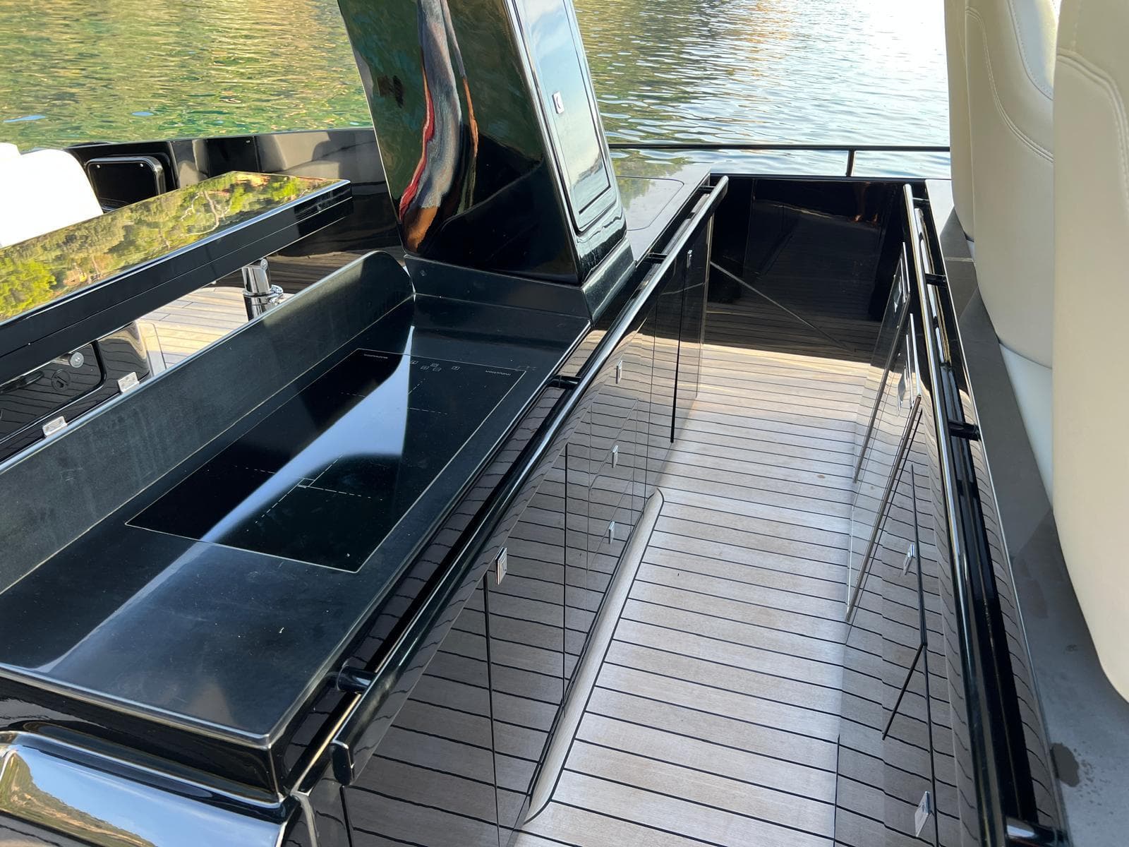 SACS Rebel 47 OB 2021 boat interior with sleek black surfaces and wood flooring.