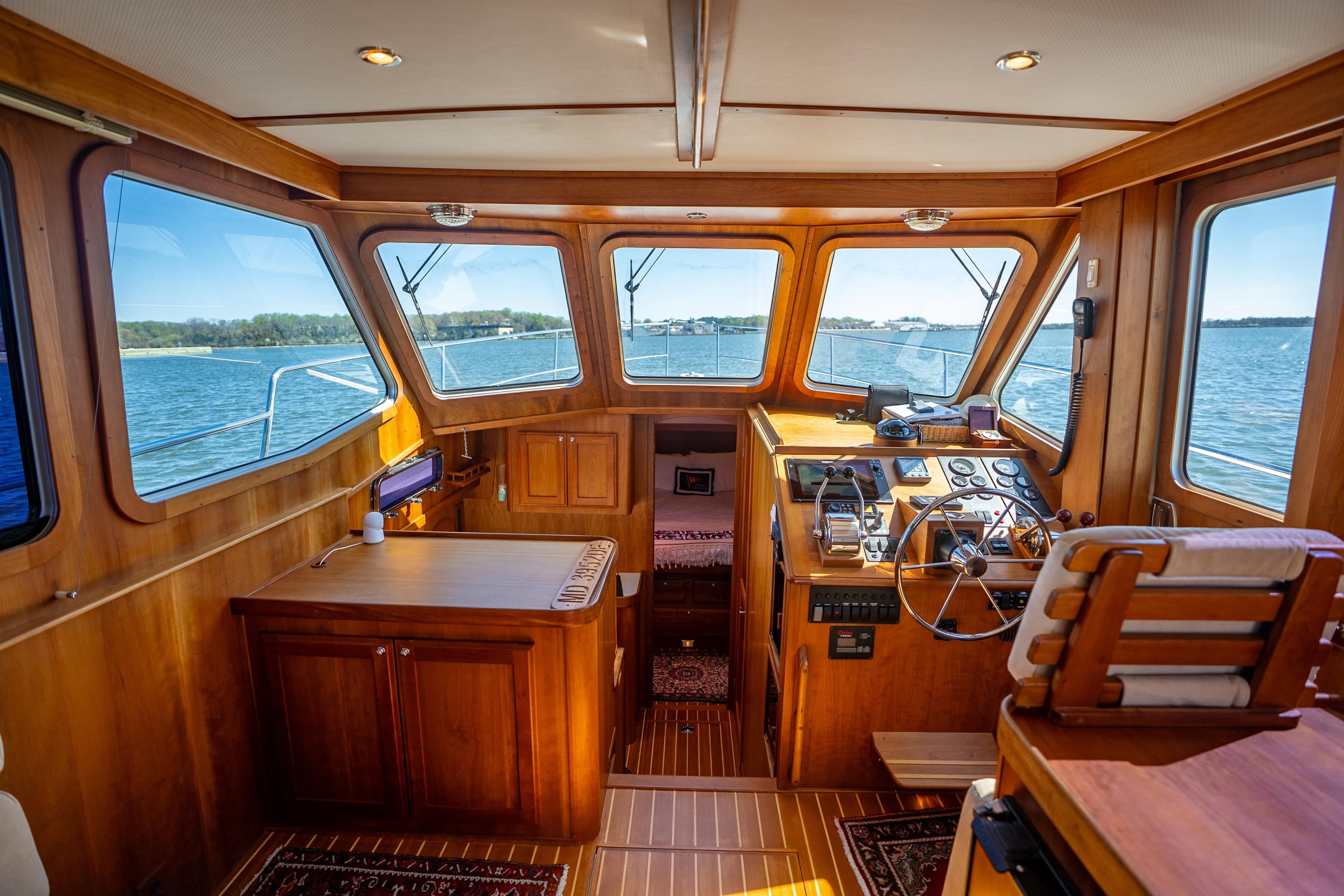 Interior of 2006 Sabreline 36 Fly yacht with wooden finish and panoramic windows.