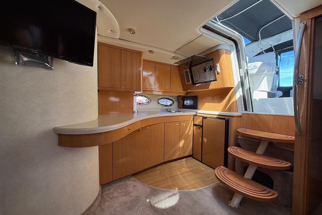 Interior of 2001 Regal Commodore 4160 yacht with wooden cabinetry and modern amenities.