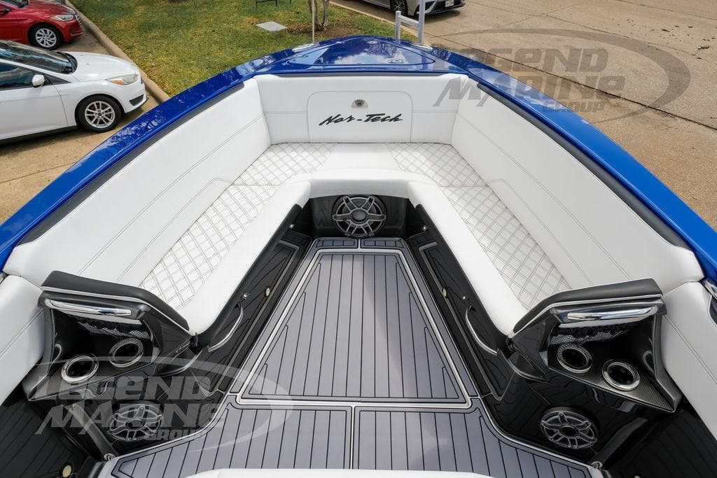 2023 Nor-Tech 390 Sport Center Console boat interior with white seating and blue accents.