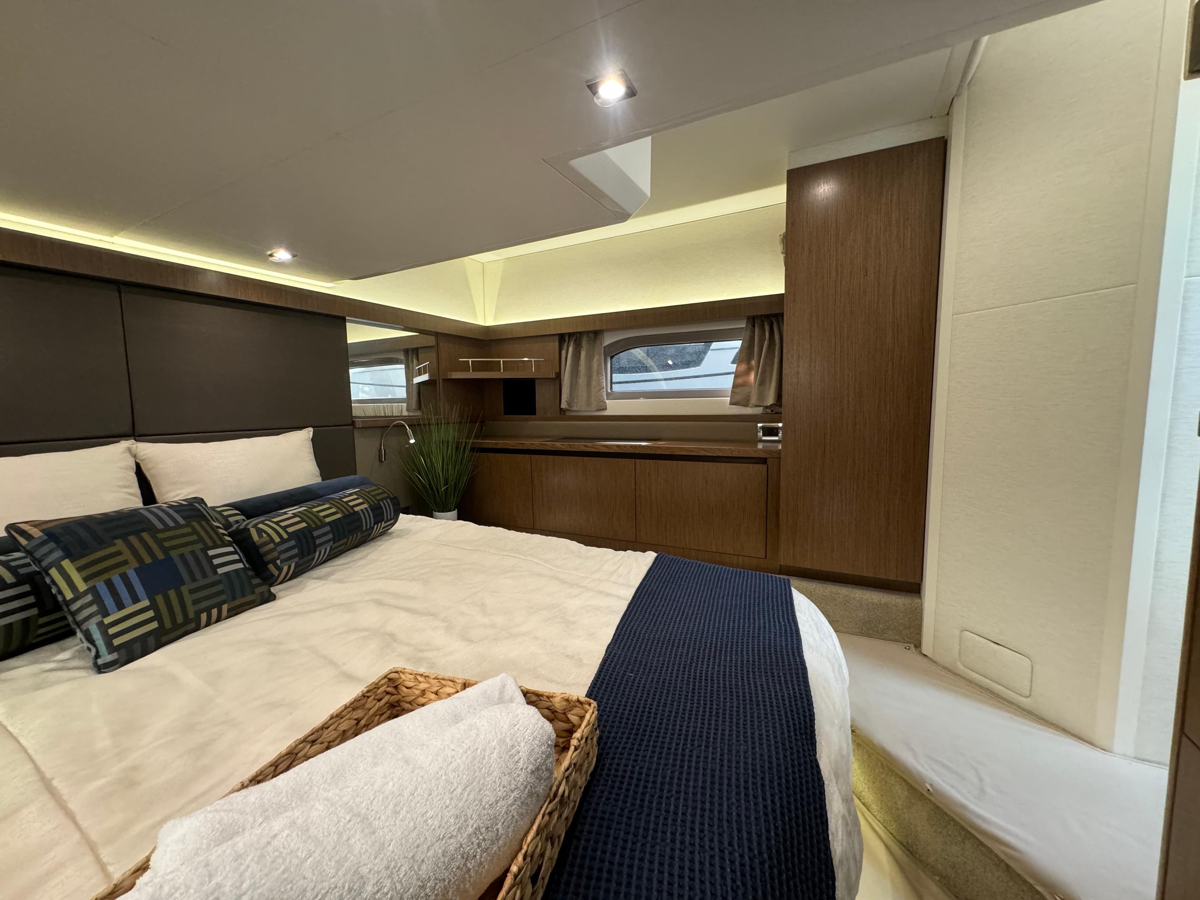 Luxurious 2017 Sea Ray Sundancer cabin interior with elegant bedding and modern wood finishes.