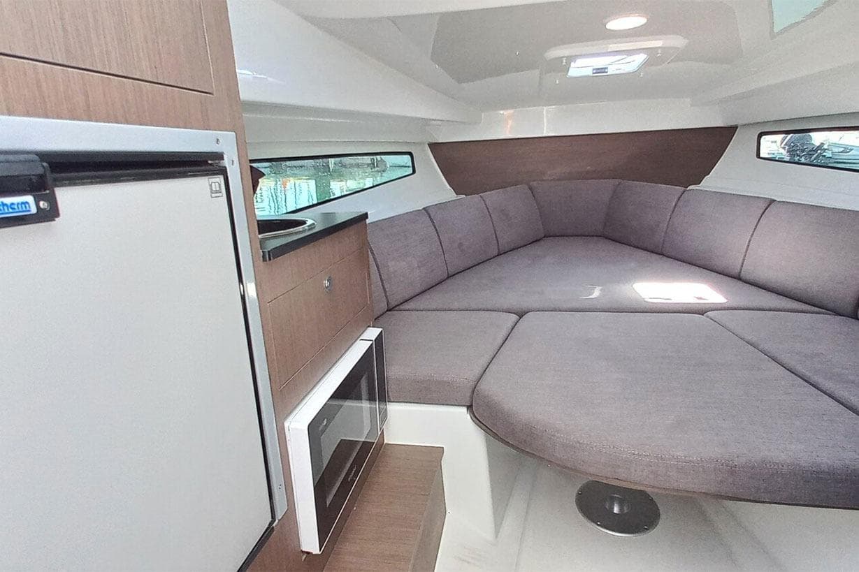 Interior of 2026 Beneteau Flyer 8 SUNdeck with cozy seating area.