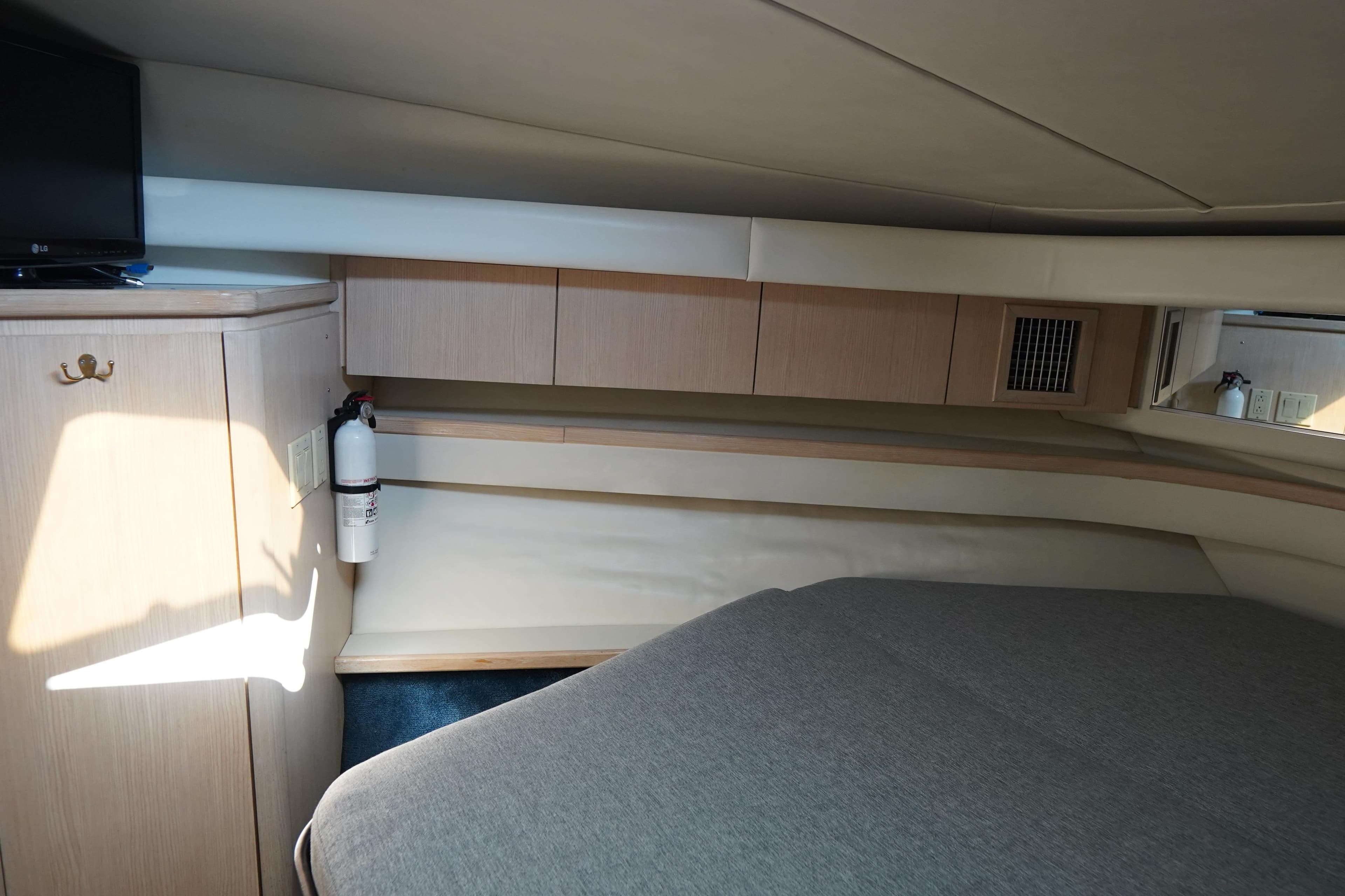 Interior cabin of 1994 Tiara Yachts 4000 Express, featuring bed and storage cabinets.