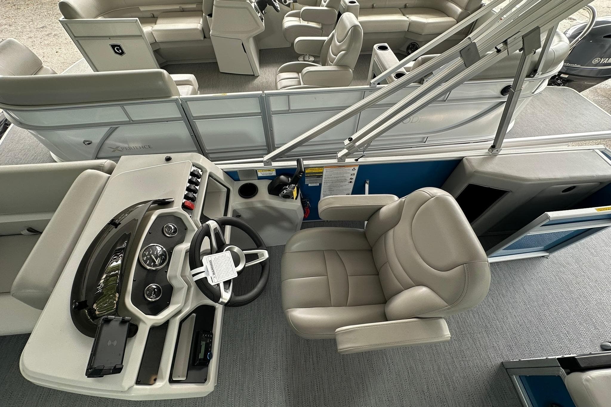 2026 Sweetwater EX2086SFLX boat interior with steering console and plush seating.